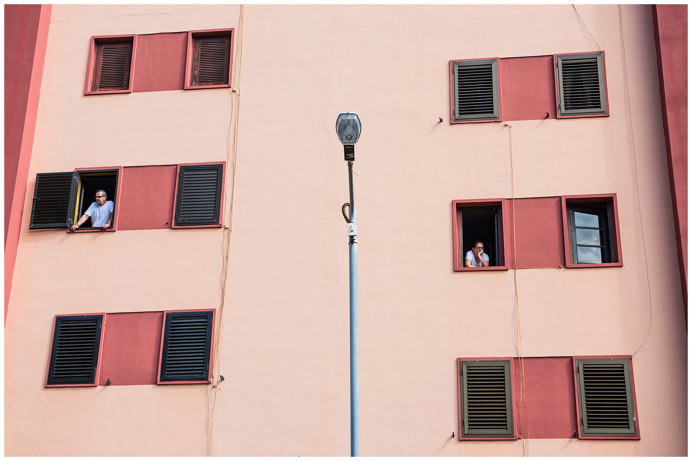 San Sebastian de la Gomera, La Gomera, Canary Islands, Spain. The inhabitants of the city of San Sebastian de la Gomera celebrate the city festival Romeria. A man and a woman look out of the windows.