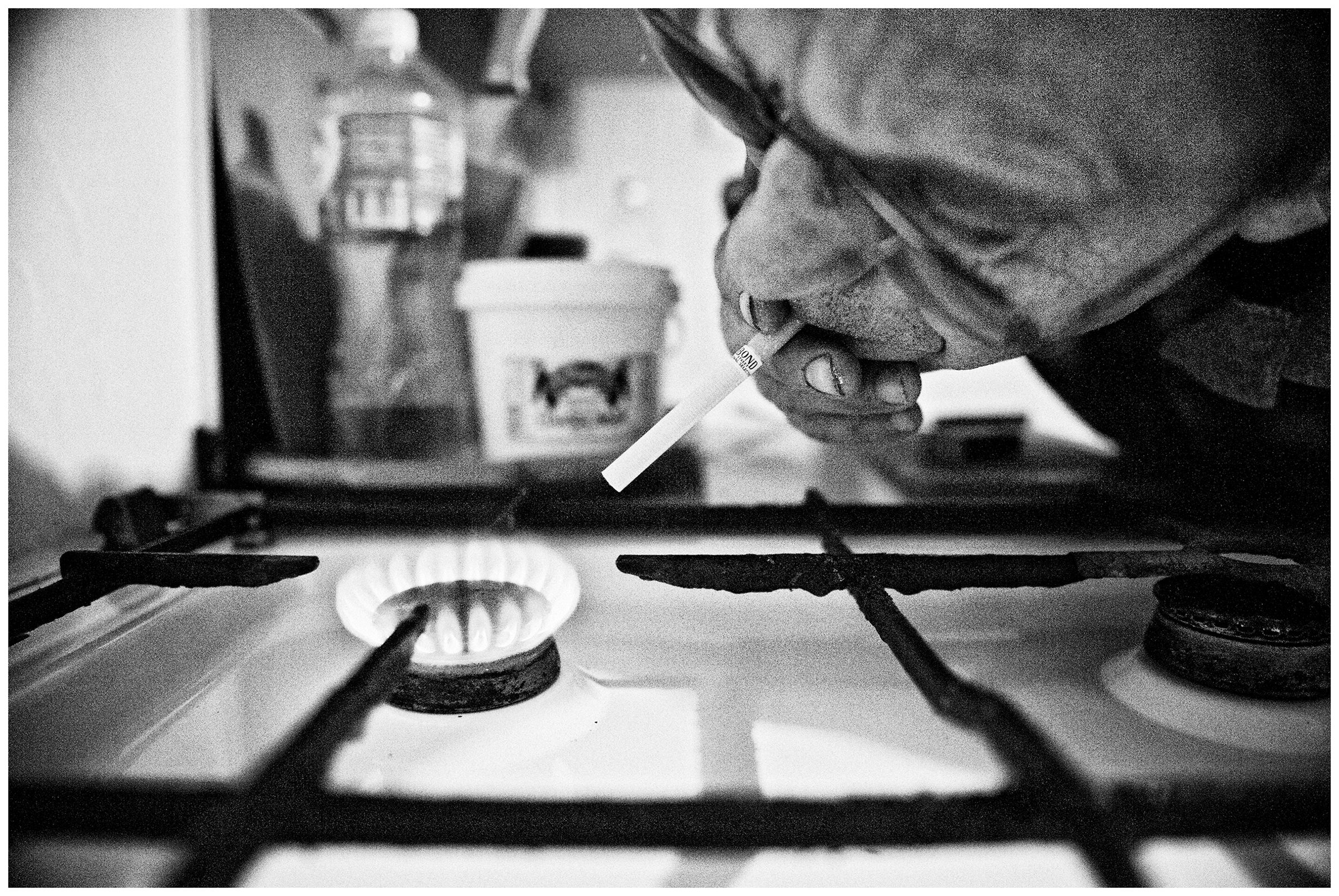 Kaliningrad, Russia. A man lights a cigarette from a gas stove.