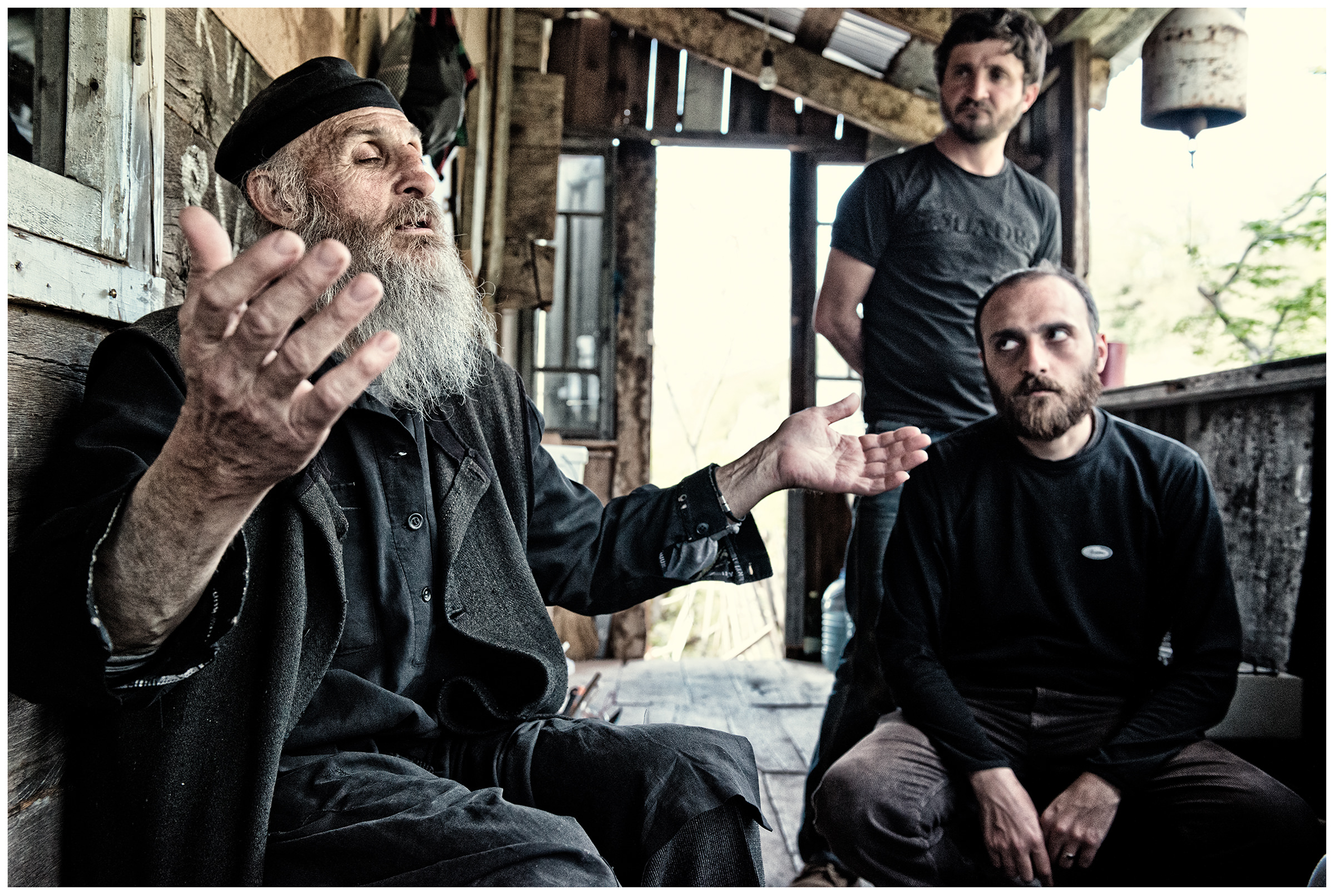 Imereti, Georgia. The Georgian monk Maxime Kavtaradze talks to his friends in his house on a rock.