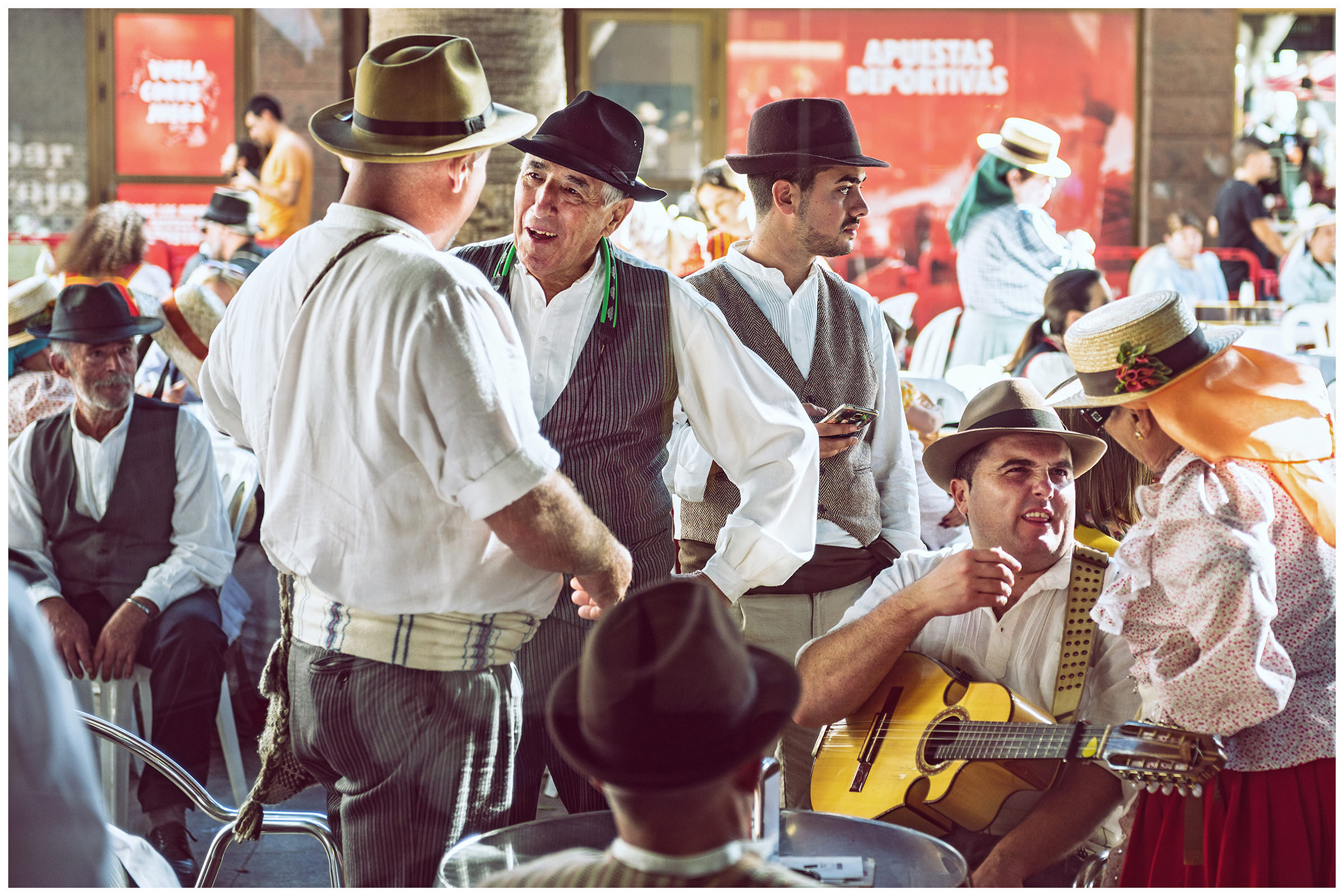 San Sebastian de la Gomera, La Gomera, Canary Islands, Spain. The inhabitants of the city of San Sebastian de la Gomera celebrate the city festival Romeria. Men play guitar and talk.