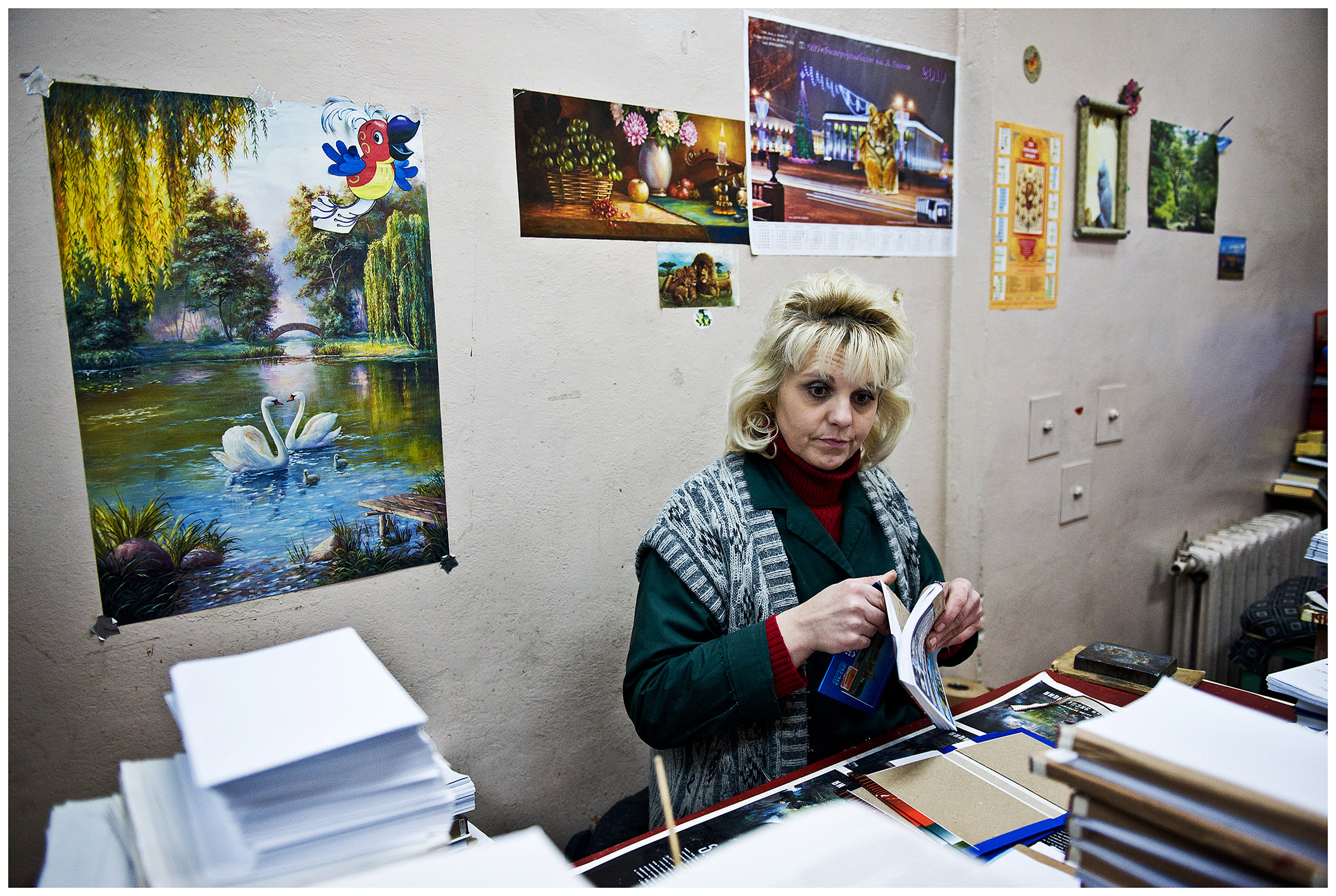 Minsk, Belarus, the publishing house "Pechatny Combinat". A worker works on the headings. On the wall there are cutouts from earlier productions.