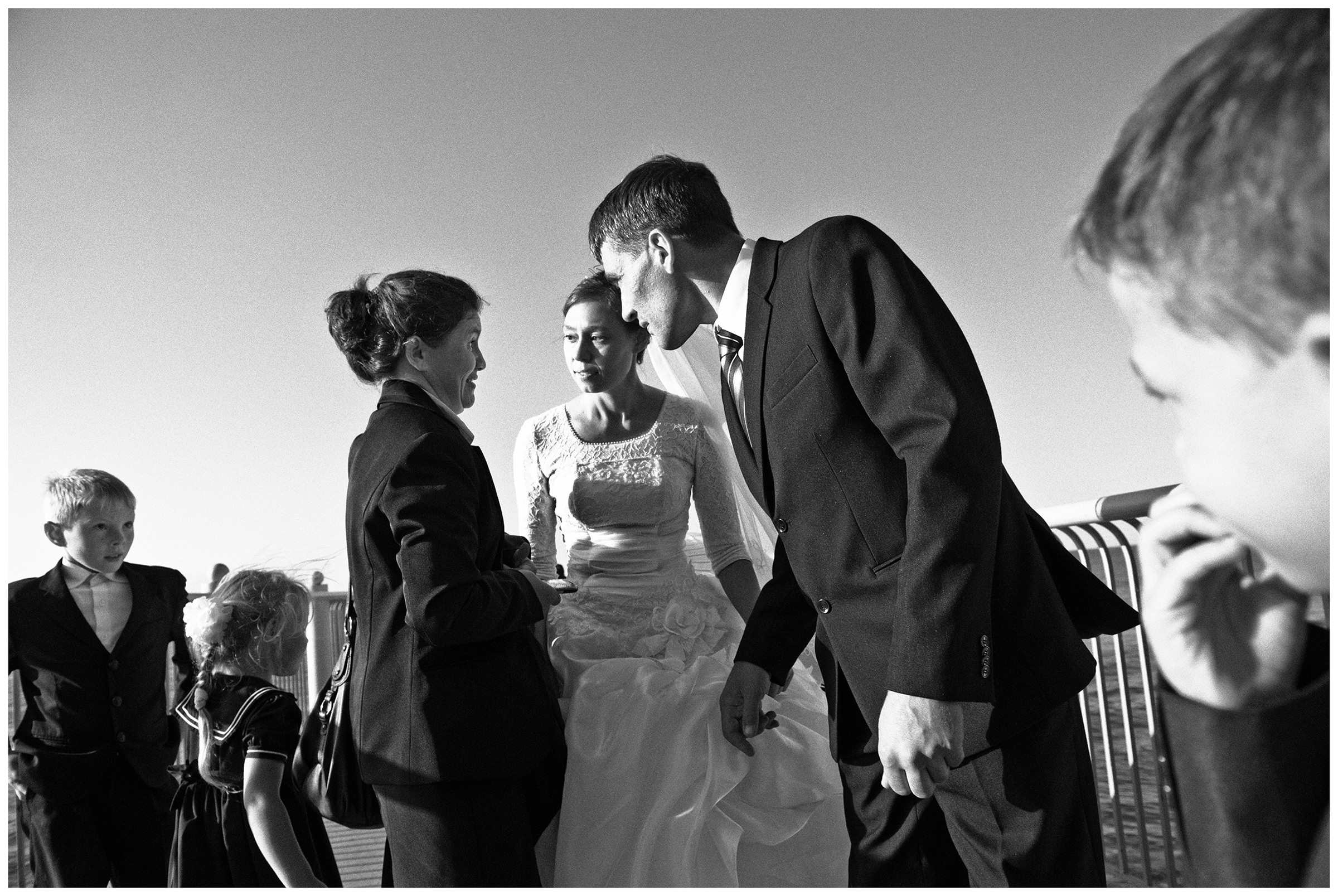 Kaliningrad, Russia. A wedding couple talks to a woman in Svetlogorsk.