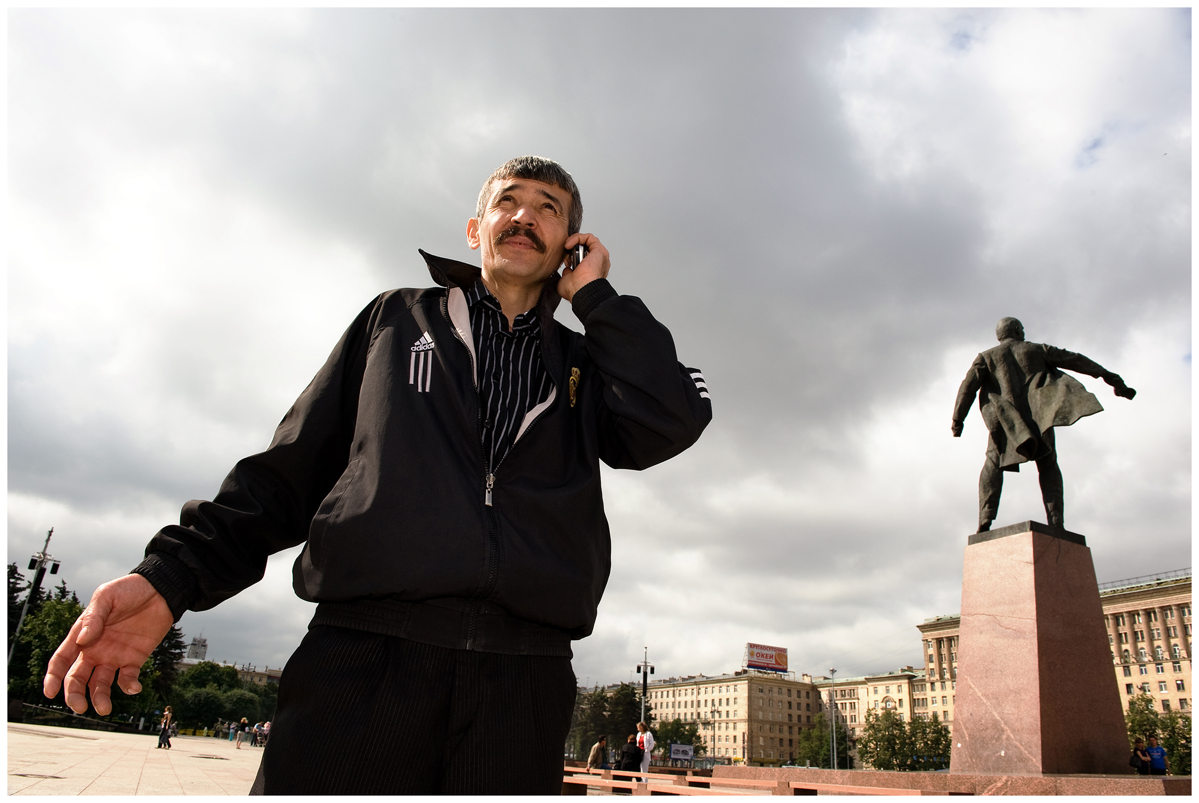 Saint Petersburg, Russia. An Uzbek guest worker on the phone at Lenin Square.