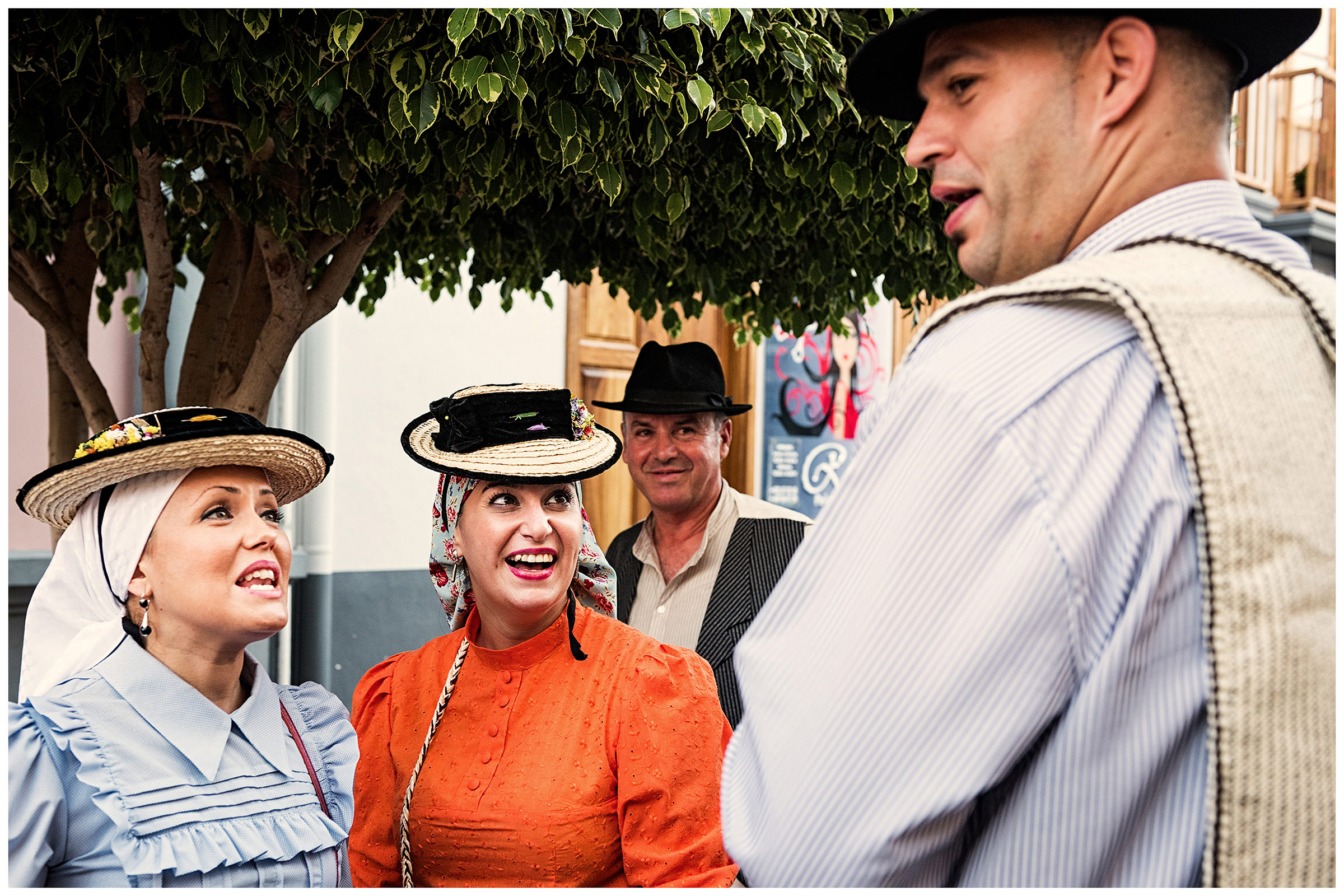 San Sebastian de la Gomera, La Gomera, Canary Islands, Spain. The inhabitants of the city of San Sebastian de la Gomera celebrate the city festival Romeria. Two women talk to a man.