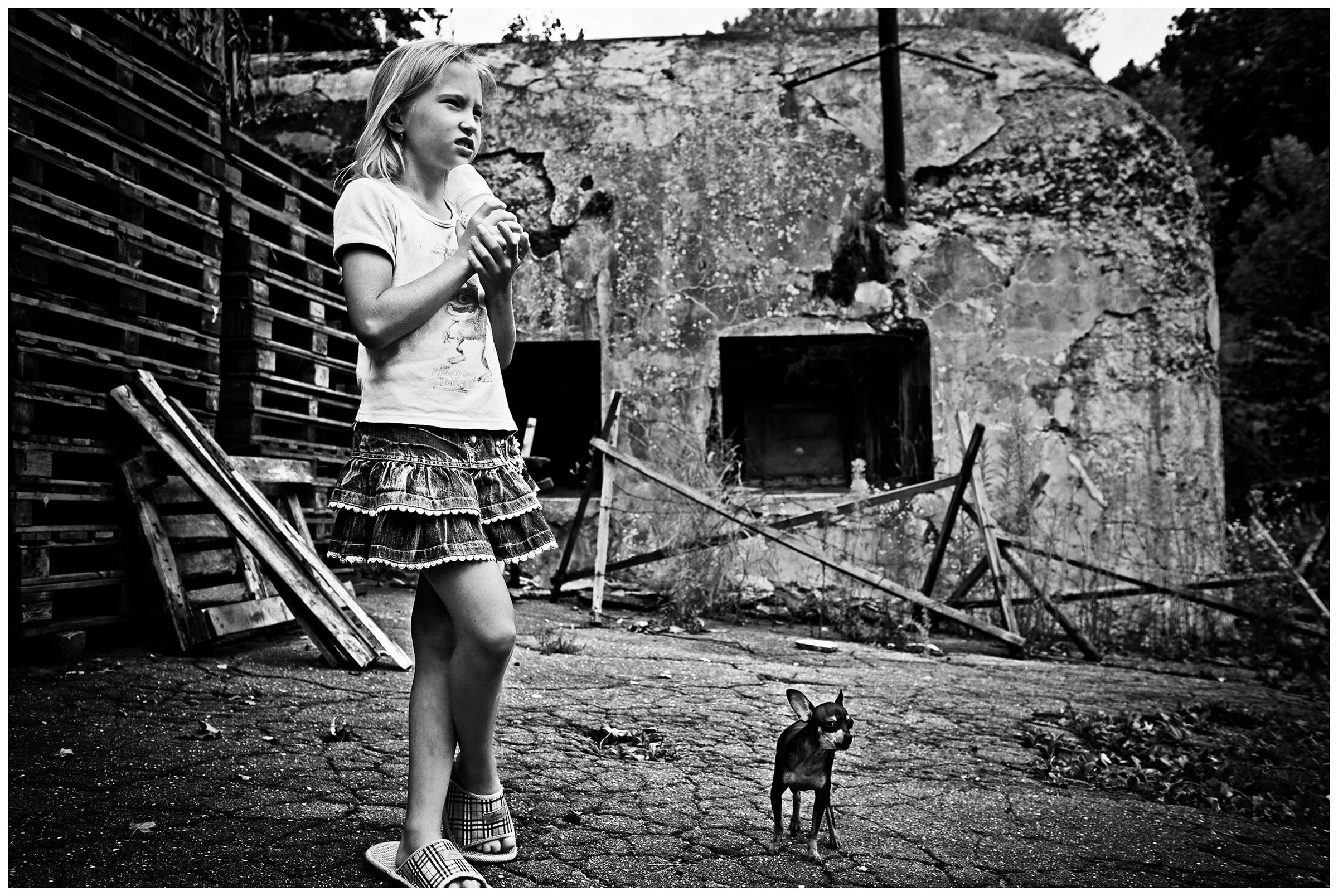 Kaliningrad, Russia. A girl stands with a dog on the grounds of Fort Stein.