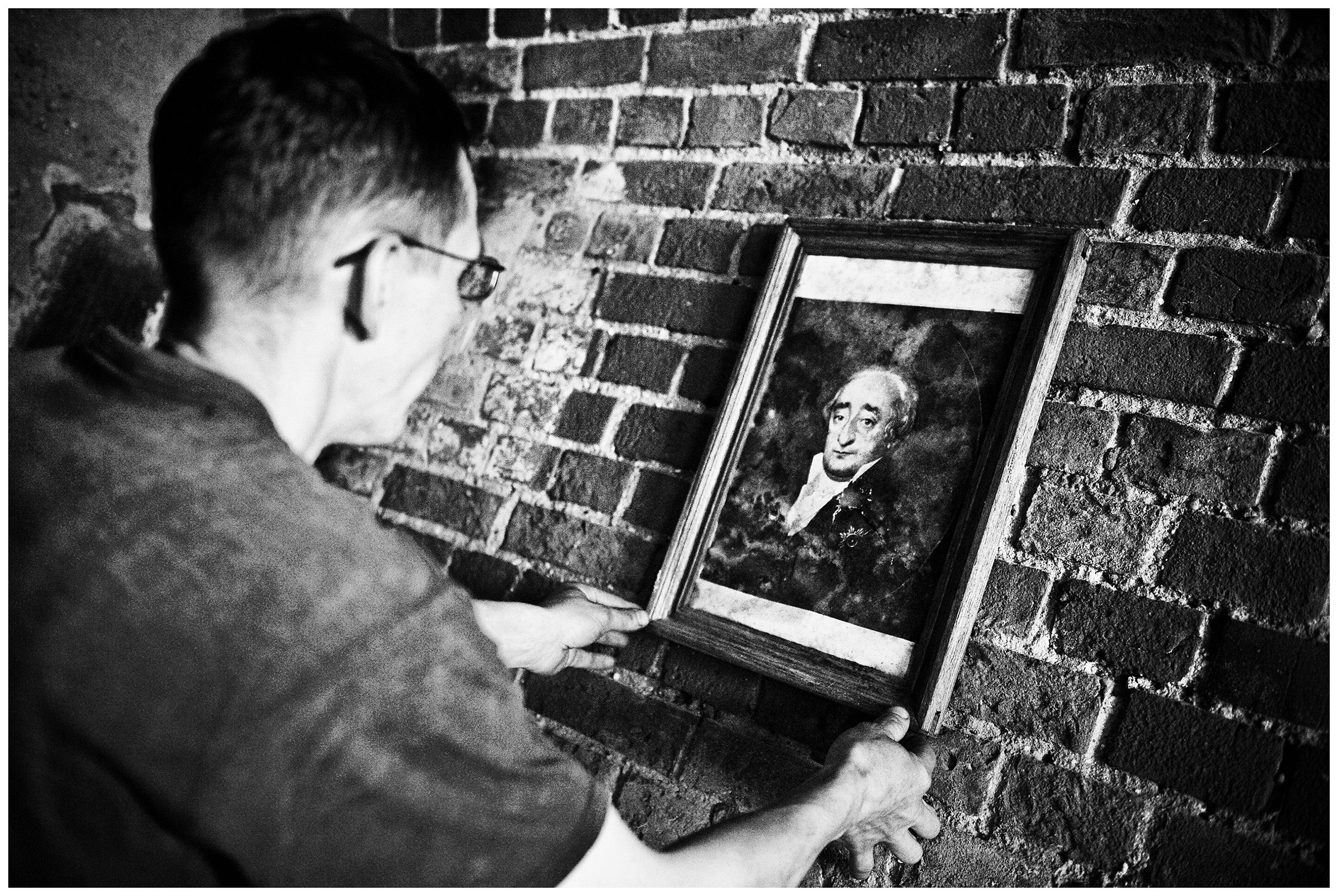 Kaliningrad, Russia. A man hangs a portrait on the site of Fort Stein.