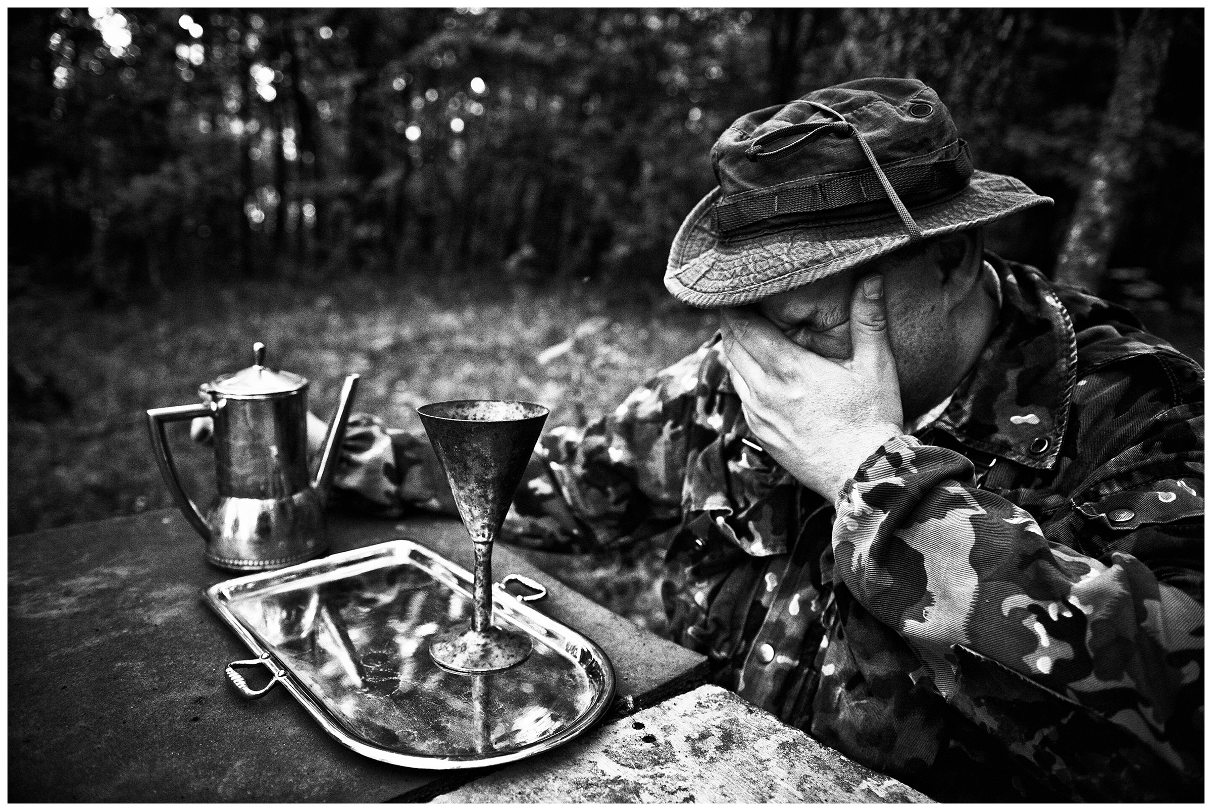 Kaliningrad, Russia. An illegal archaeologist sits in front of his finds in a forest.