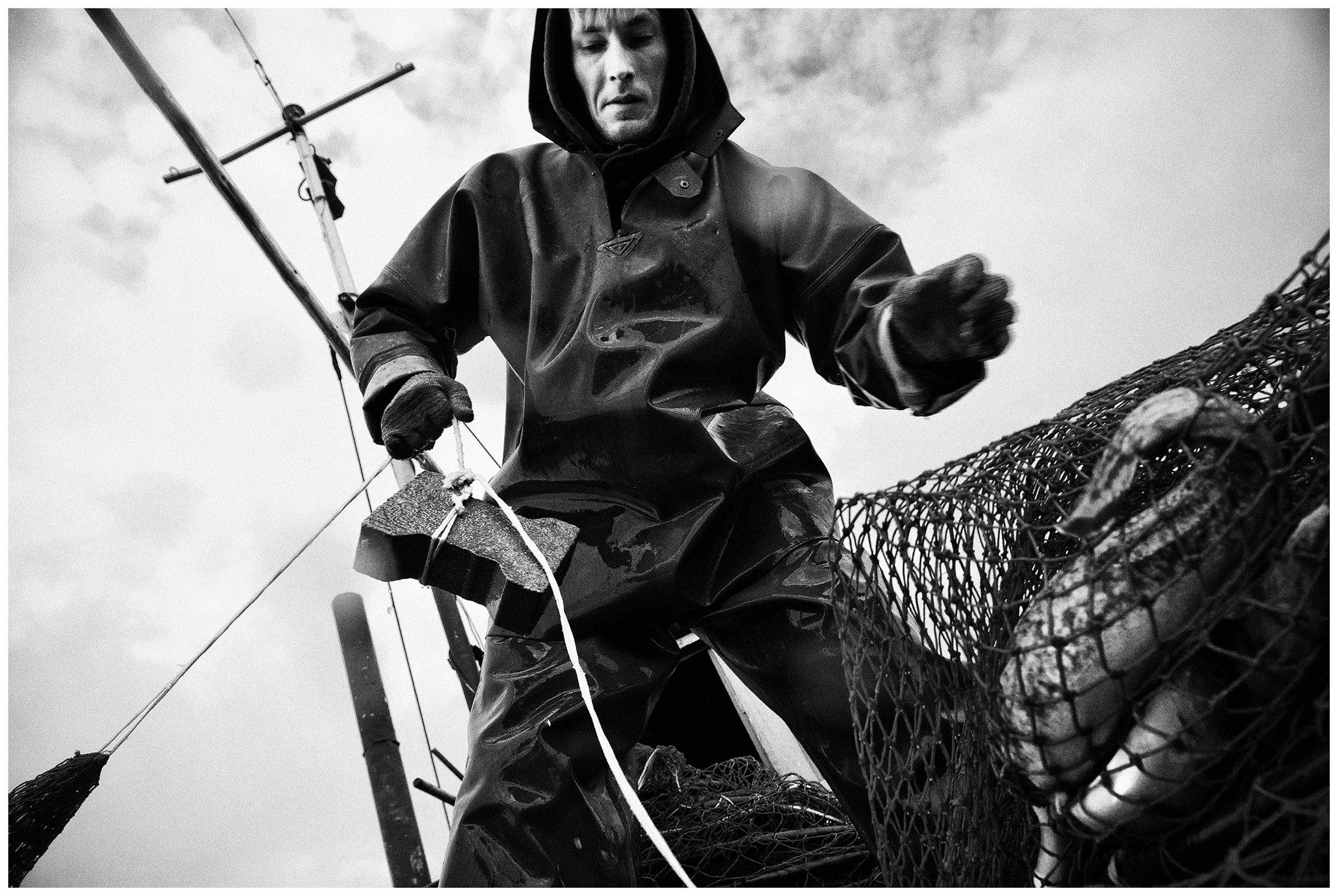 Kaliningrad, Russia. A fisherman pulls nets out of the water.
