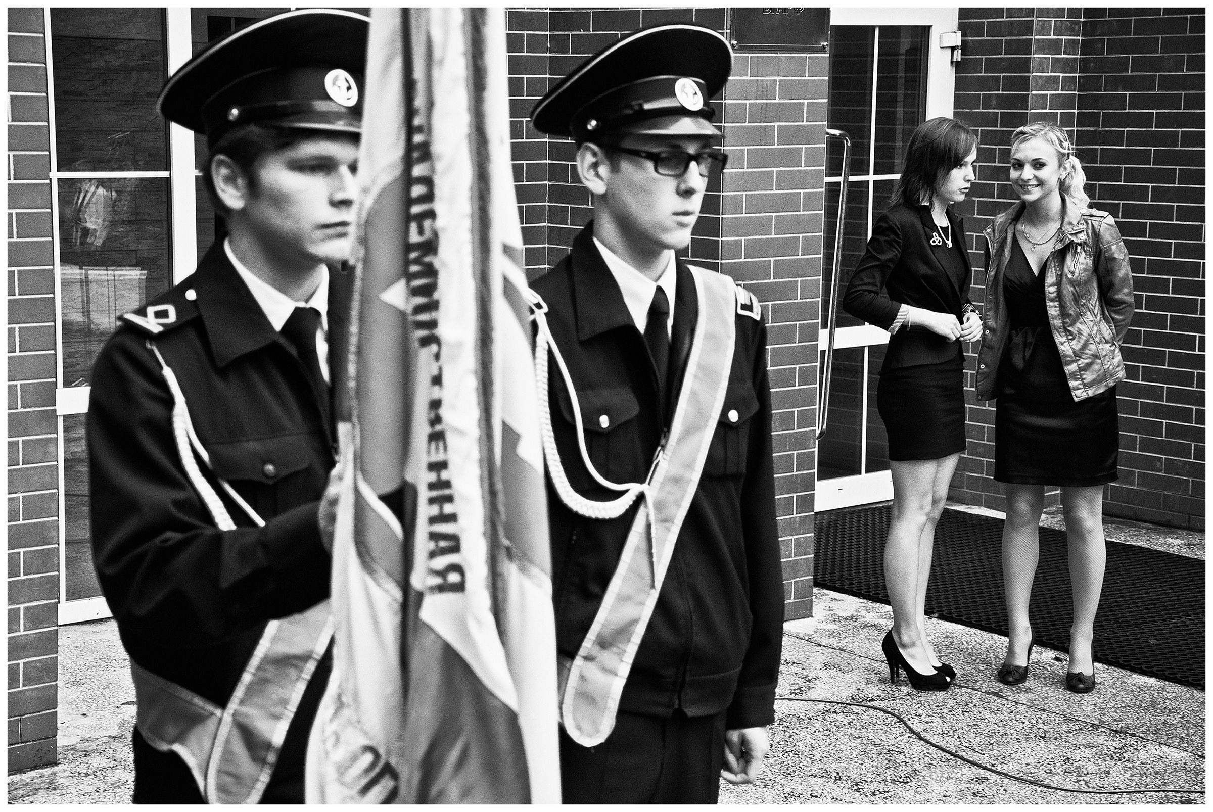 Kaliningrad, Russia. Cadets and two young women stand in the courtyard of a cadet school.