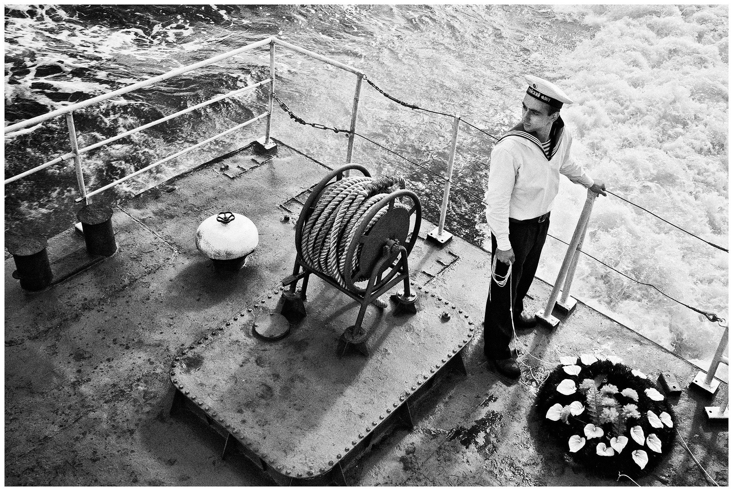 Kaliningrad, Russia. A sailor is standing on board a warship with a wreath.