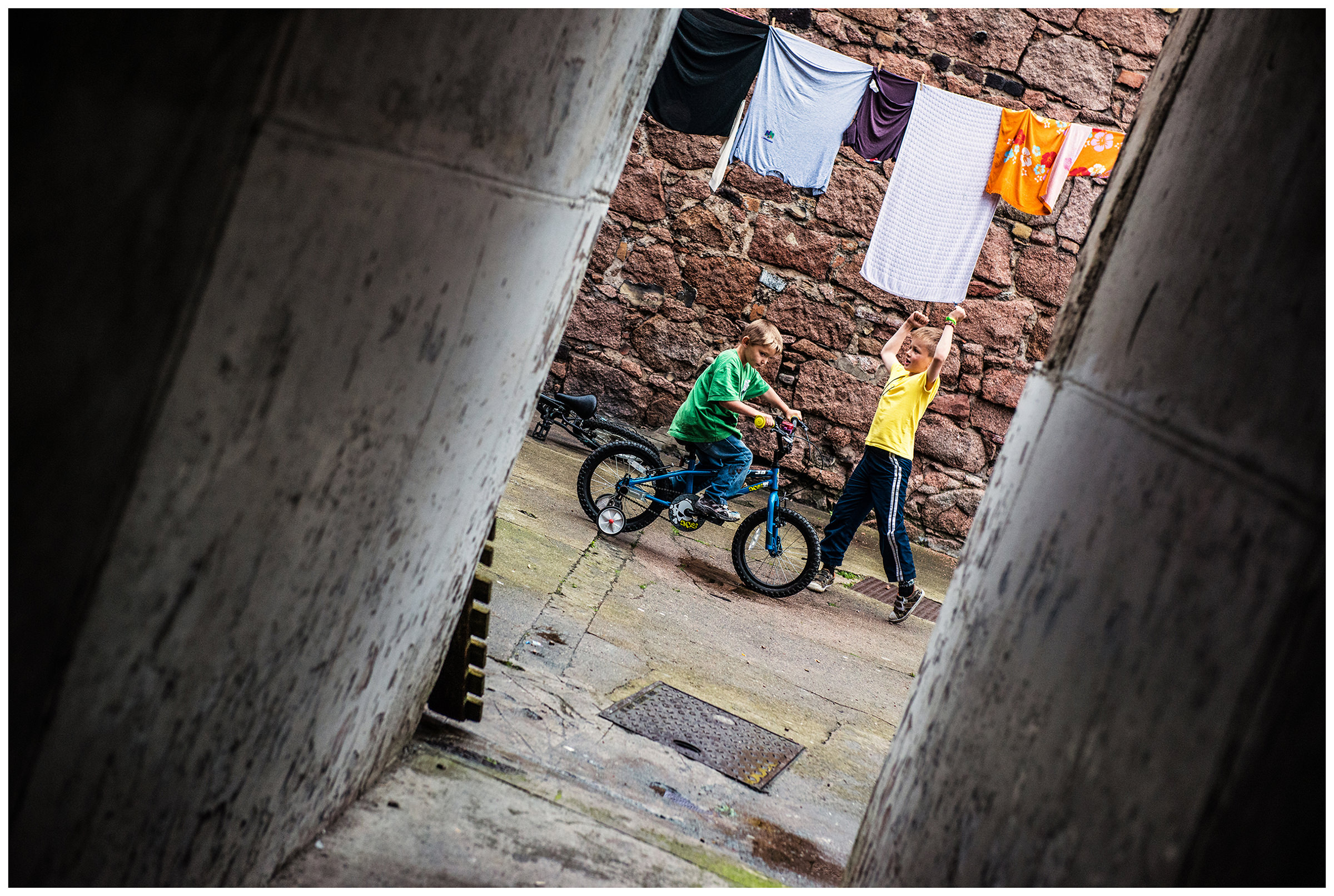 Scotland, Peterhead. Children playing in a backyard.