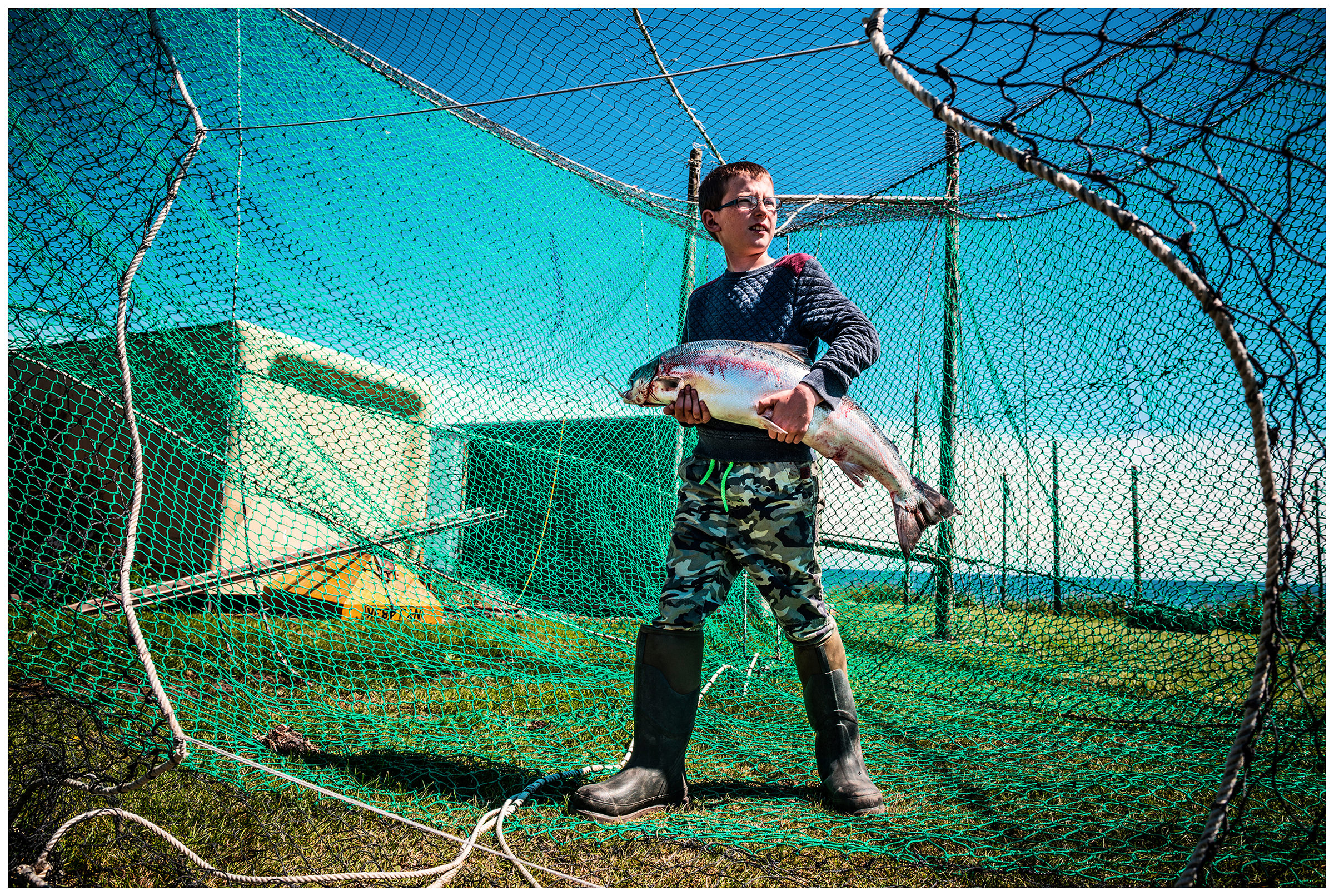 Scotland, Usan Montrose. A boy keeps a big fish.