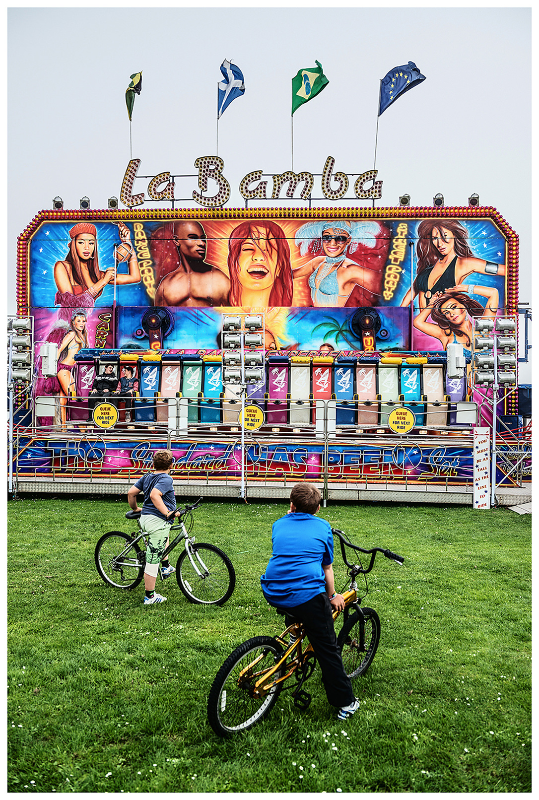 Scotland, Peterhead. Two boys on bicycles looking at an attraction.