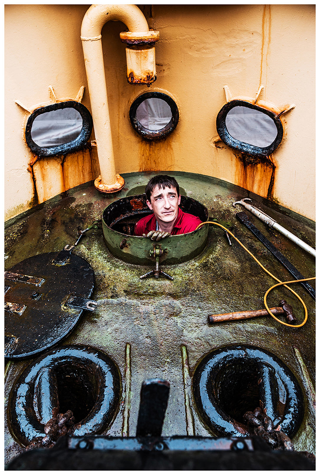 Scotland, Fort William. A man repairs a ship at the Corpach Boat Building repair yard.
