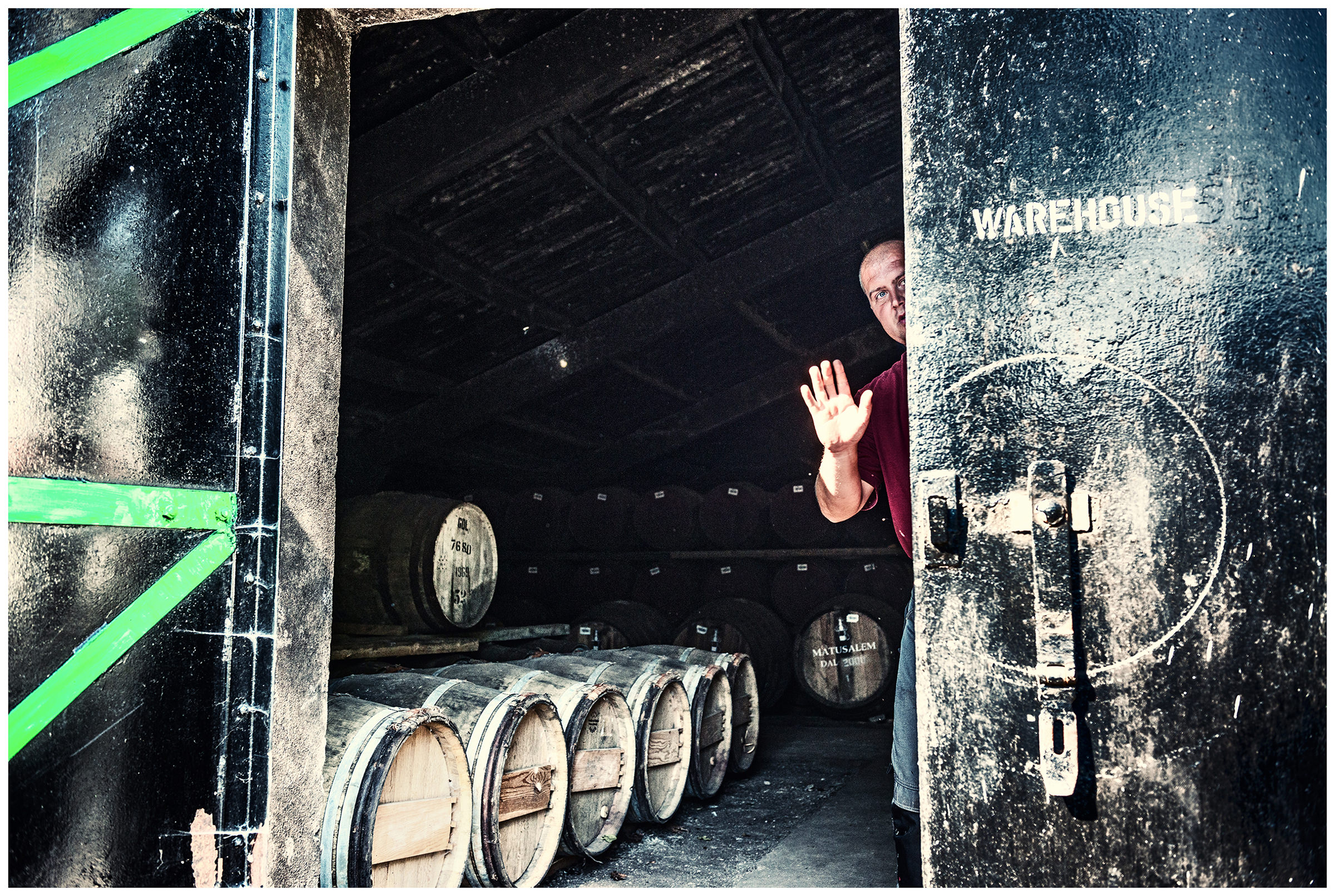 Scotland, Dalmore. A man is standing in the storage room for wiskey. Since 14 years Kevin Dunnett works as Mashman and Stillman at the distillery "The Dalmore".