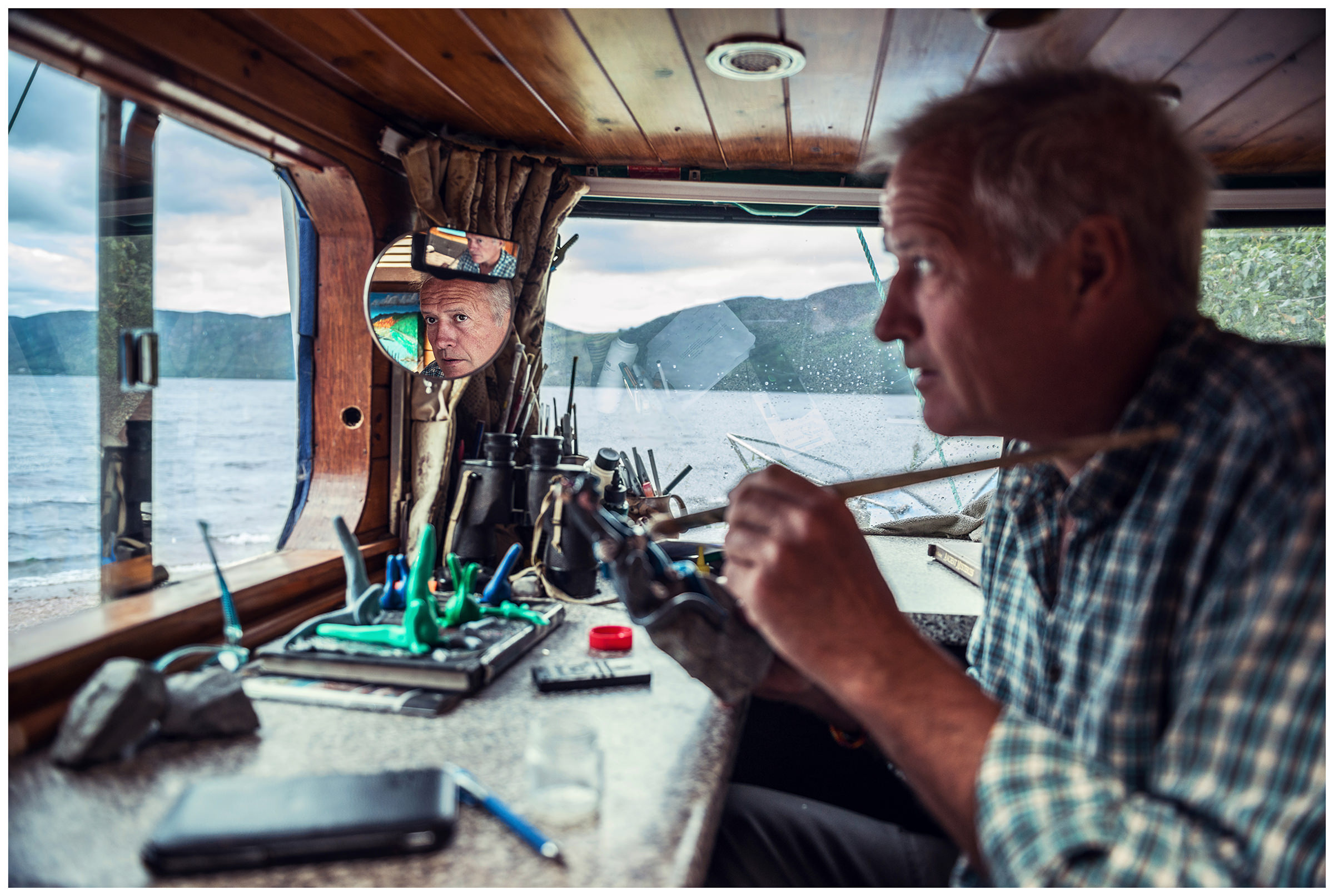 Scotland, Loch Ness. Nessy Hunter Steve Feltham spends all his time at Loch Ness Coast, where he has been living in a motorhome since 1991. He makes little Nessys out of clay for tourists.
