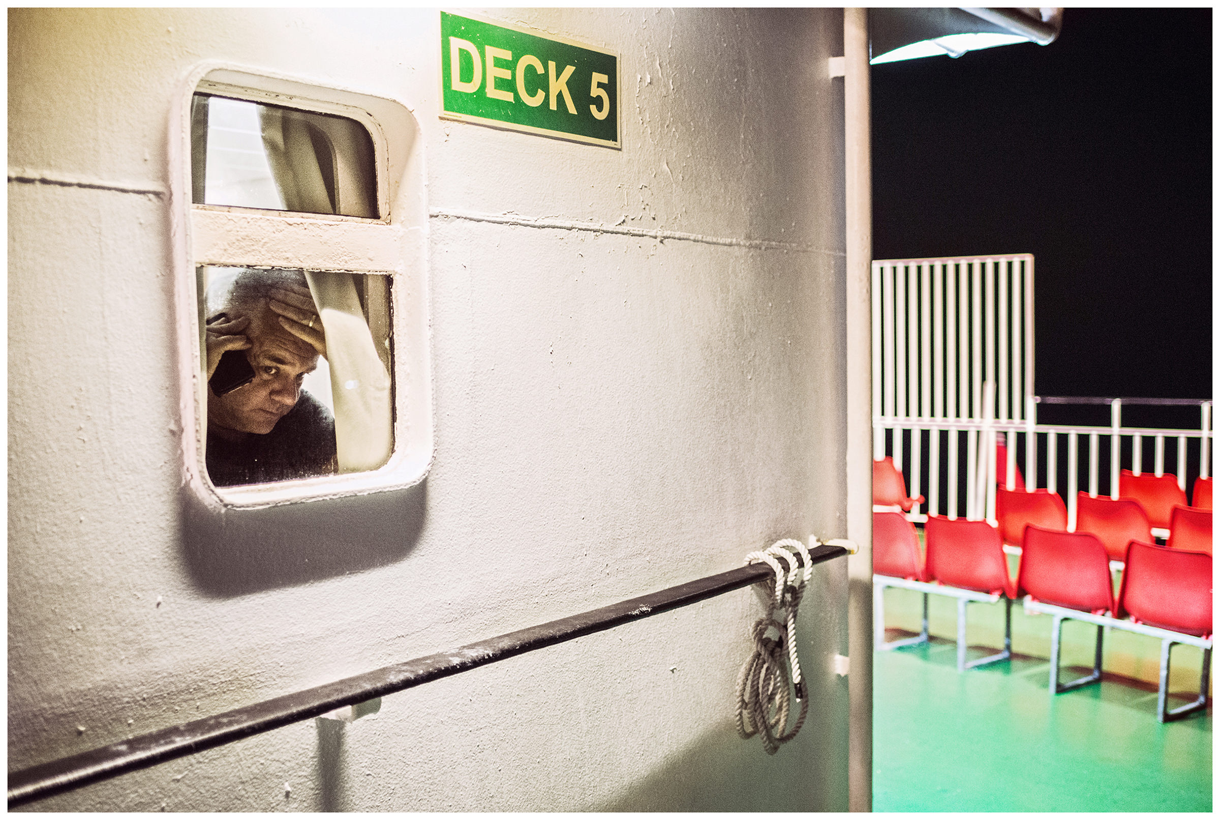 Scotland, on board a ferry between Ullapool and Isle of Lewis. A man on the phone on board the ferry.