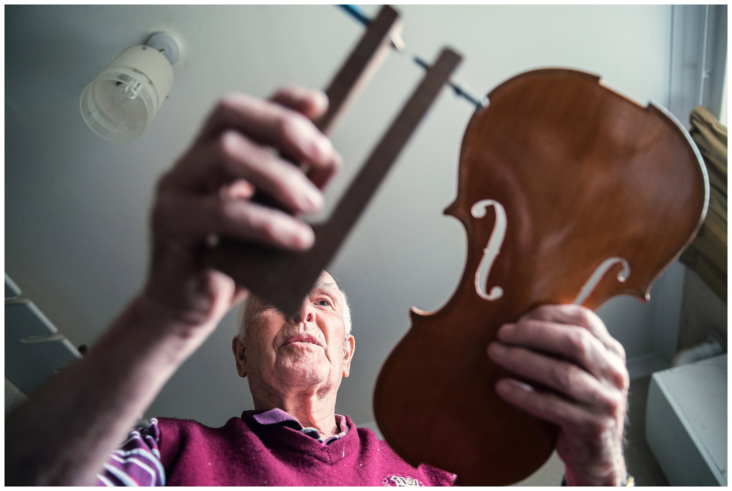 Scotland, Fort William. An old man makes a violin.