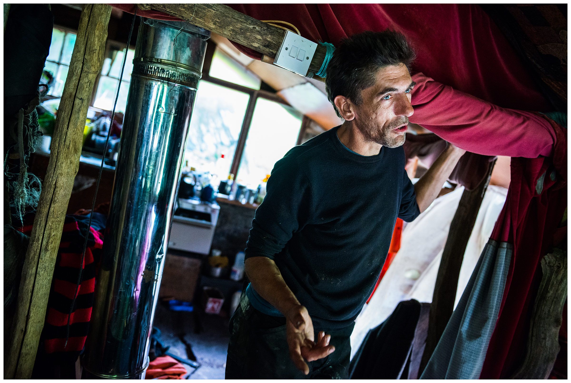 Scotland, near Polish A downshifter stands in his self-built house made of clay bricks in a secluded location in the forest near Polish.