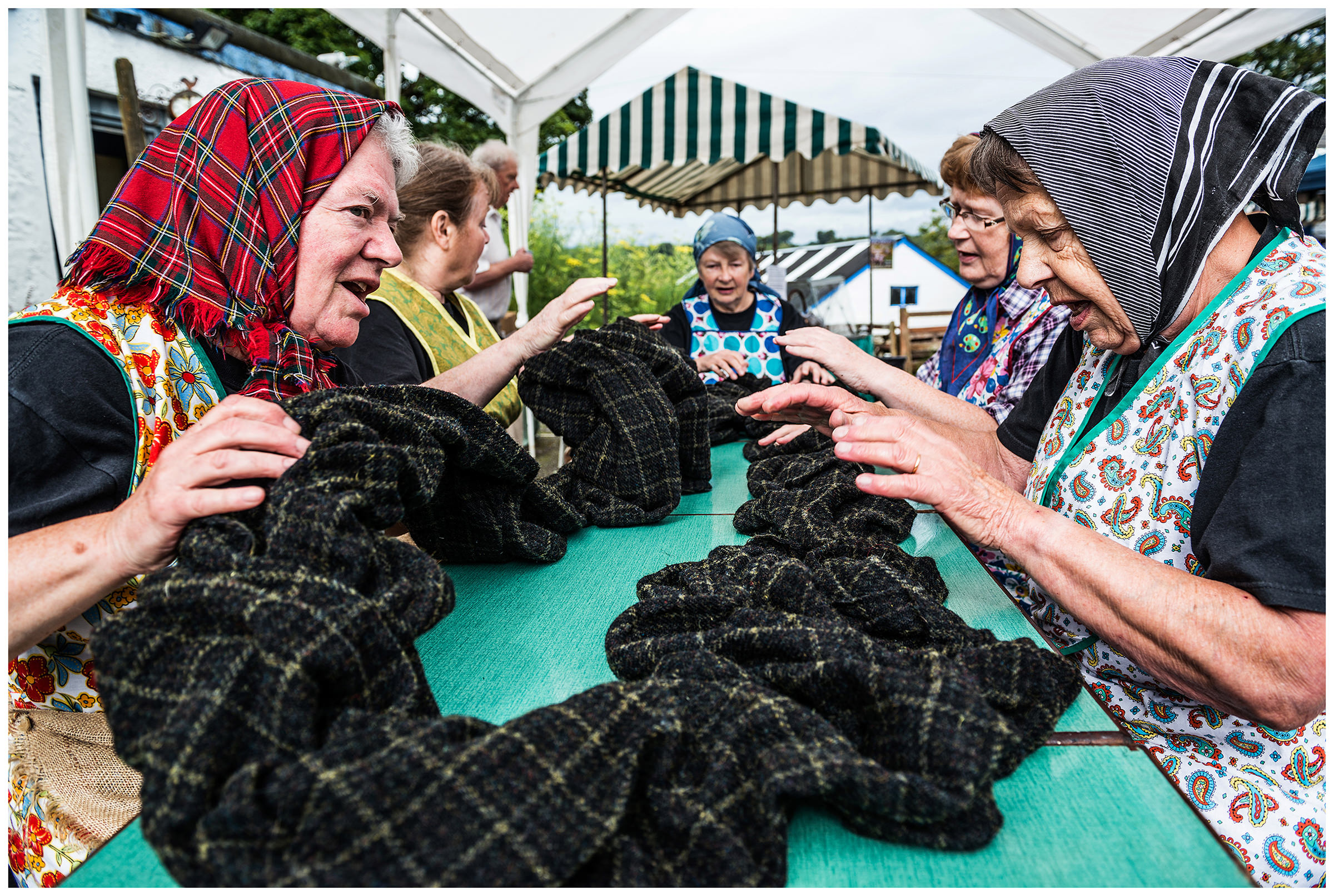Scotland, Benderloch The wool festival in Benderloch. One group has specialized in the Gaelic work songs, especially the songs the women sing while tweed-walking. Walking is the final stage in the production of the famous Harris tweed, in which the wet fabric is rhythmically beaten onto the table to firm and soften the fabric. Songs helped to keep the rhythm and make the work easier.