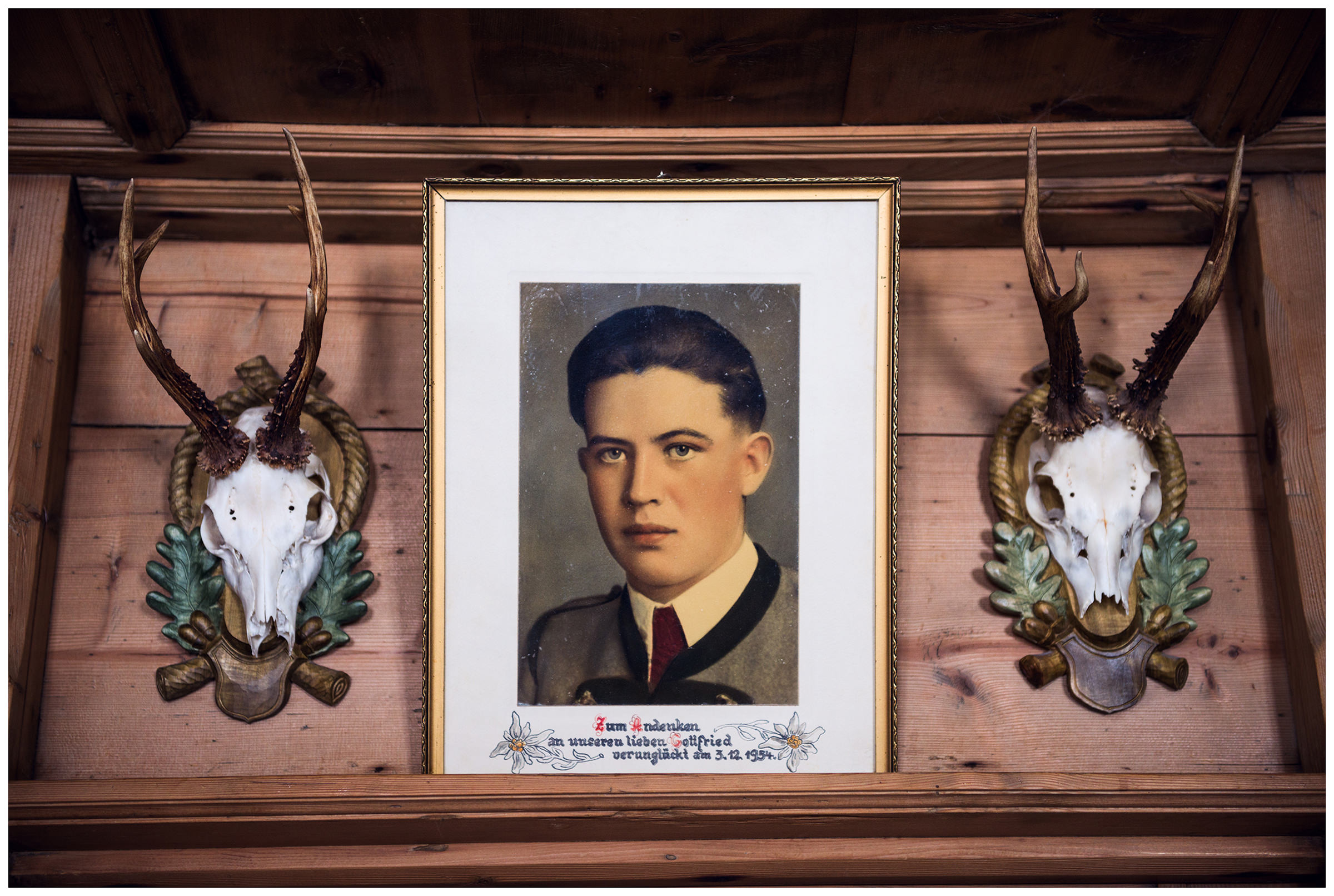 Valsertal, Wipptal, North Tyrol, Austria. A picture of a deceased relative is hanging on the wall of Annemarie Gstrein's house.