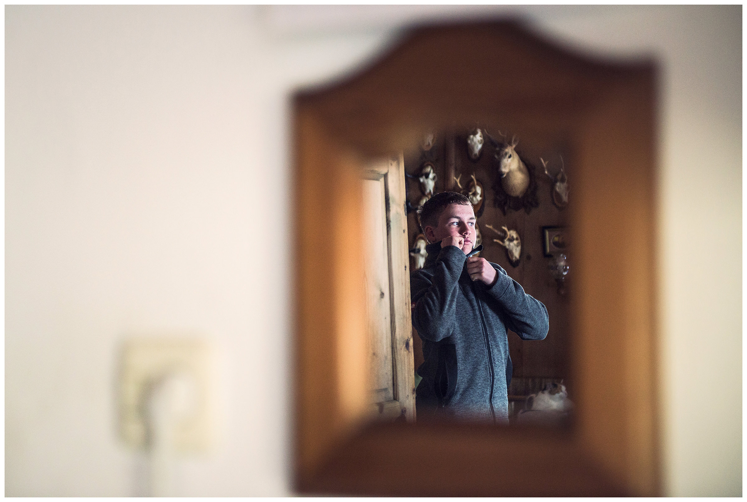 Valsertal, Wipptal, North Tyrol, Austria. A young man changes his clothes after the haymaking.