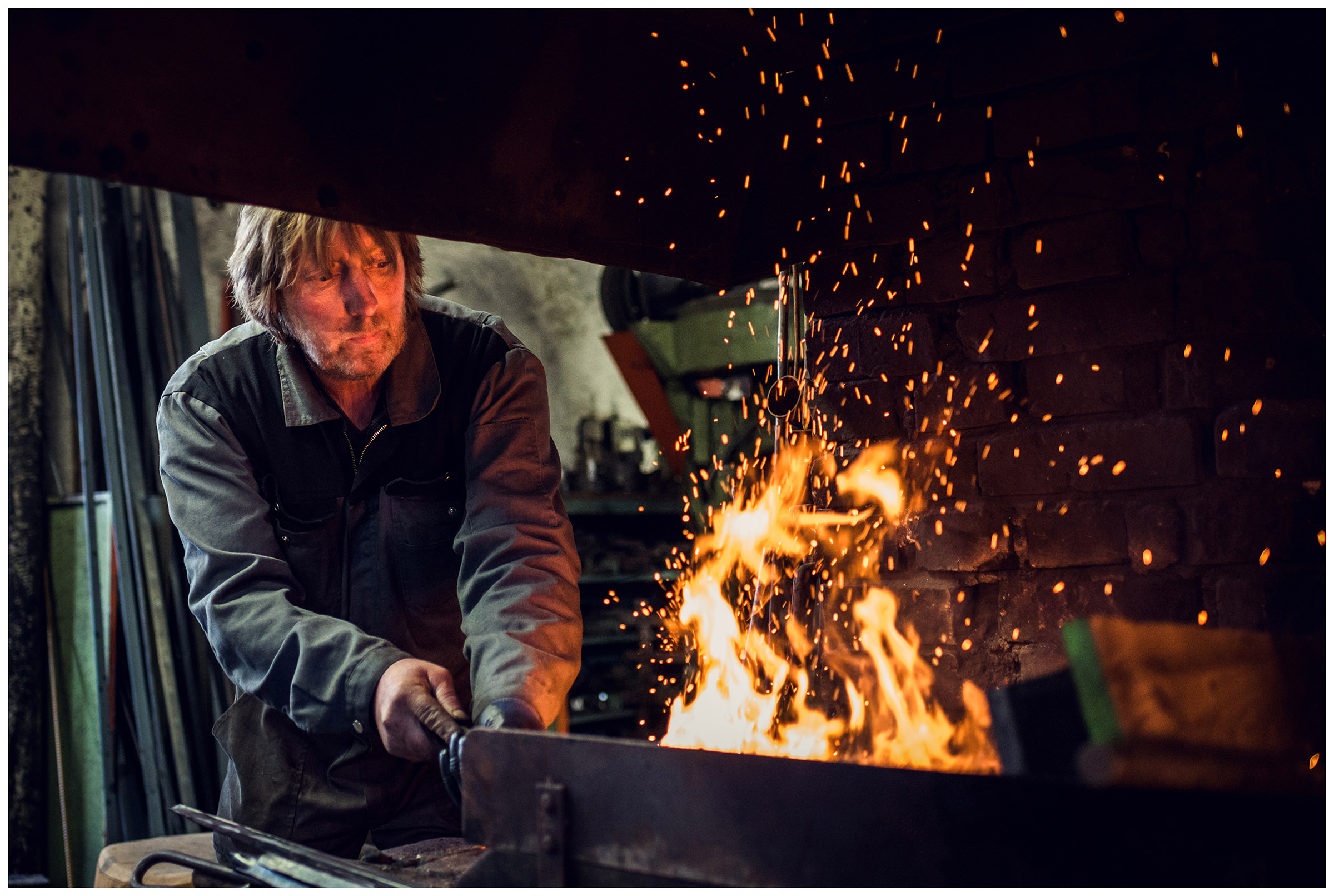 Wipptal, North Tyrol, Austria. A blacksmith works in his smithy.