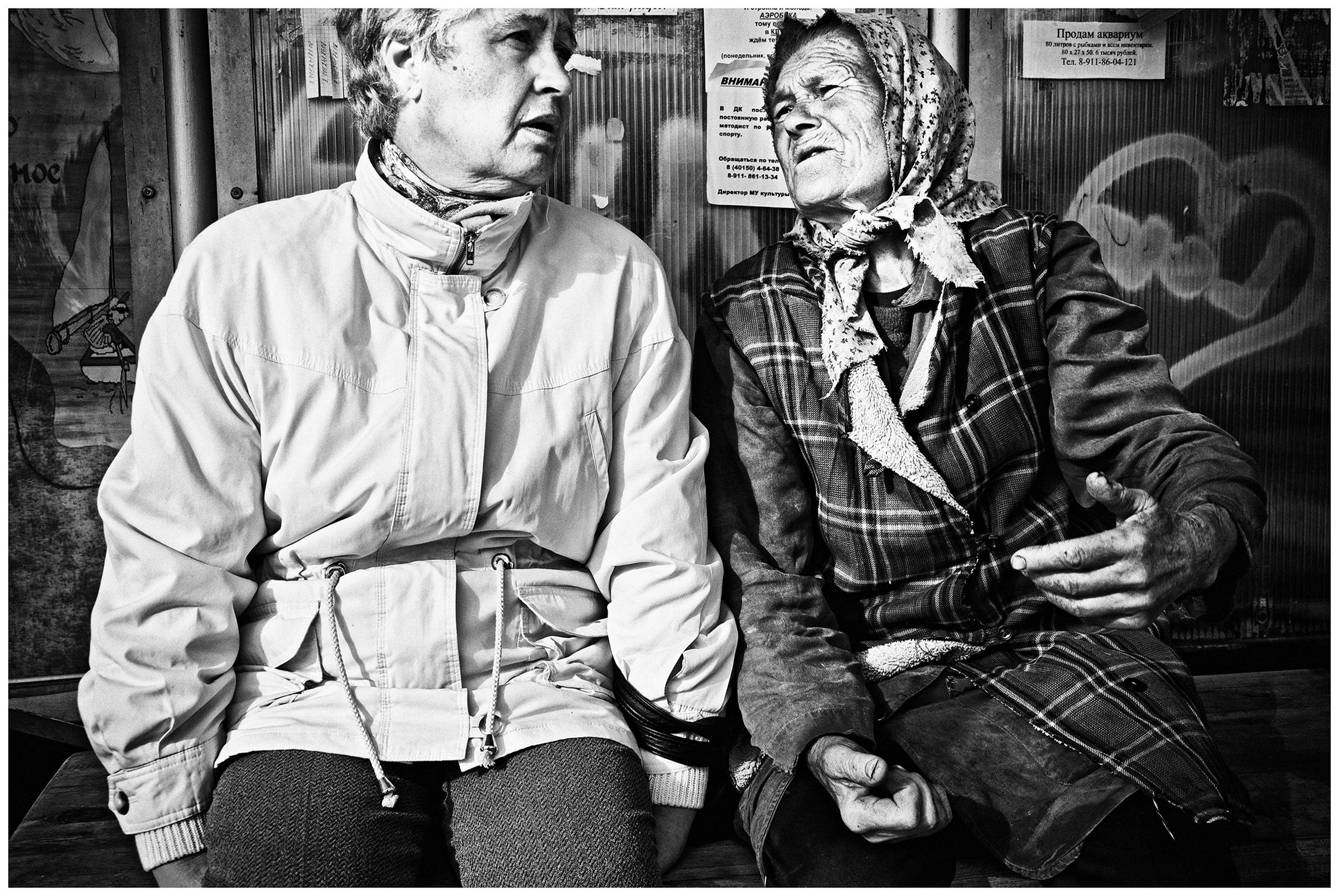 Kaliningrad, Russia. Two women waiting at a bus stop for a bus.