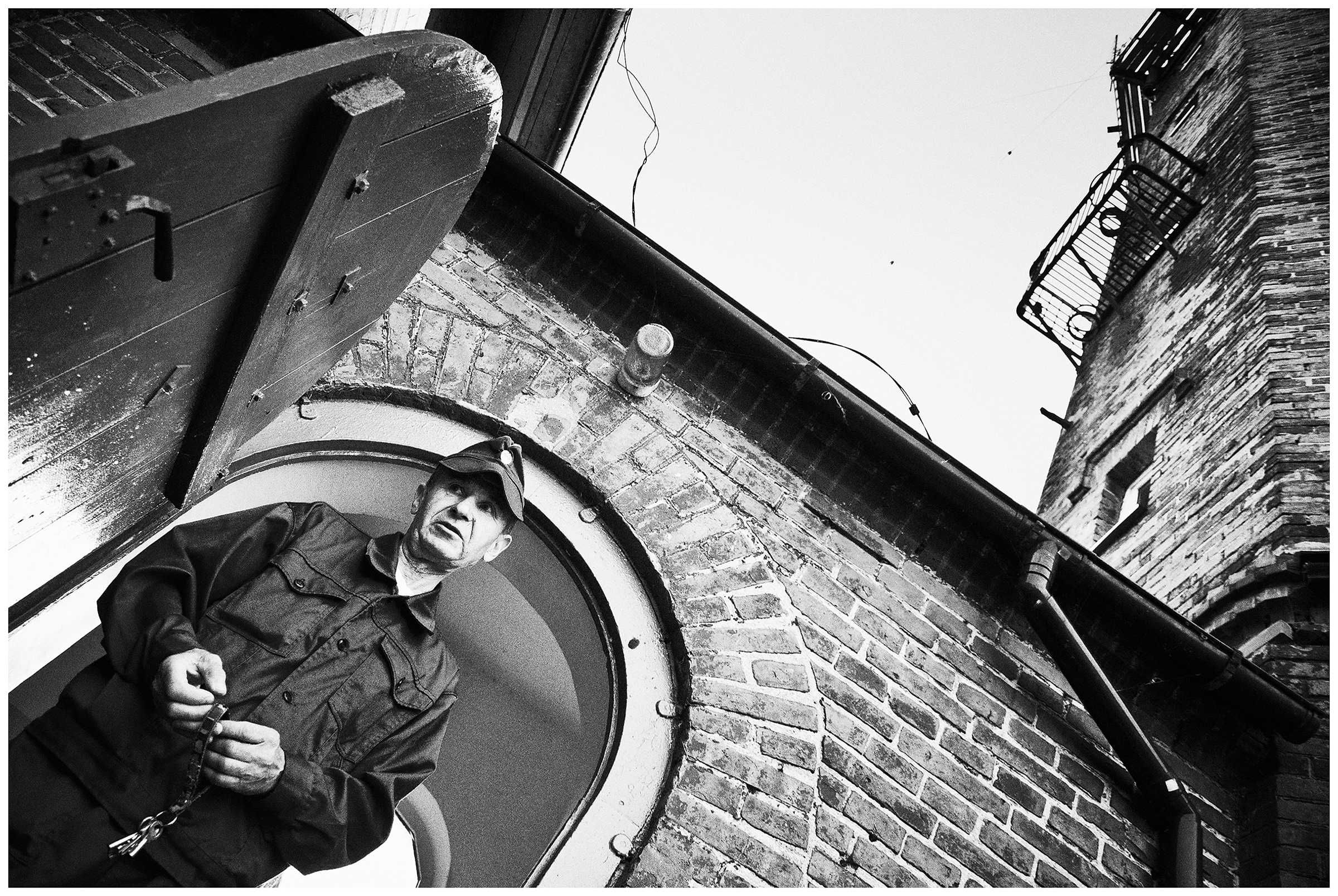 Kaliningrad, Russia. A lighthouse keeper stands with the keys in front of his lighthouse.
