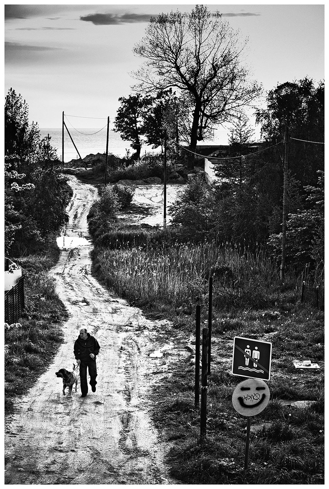 Kaliningrad, Russia. A man walks with his dog in a street in Yantarny.