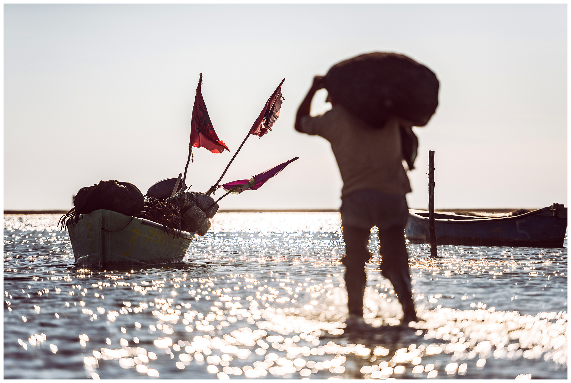 Albania, Divjakë. A fisherman in the Kara-Vasta lagoon goes to his boat.