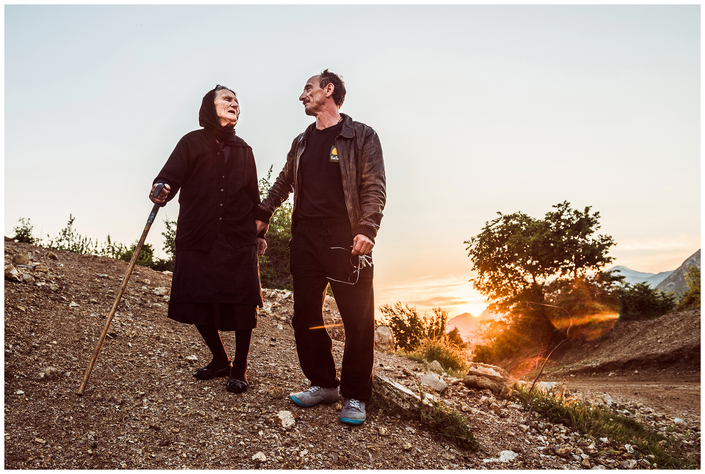 Albania, Pilur. An old woman and her nephew are standing on a village street.