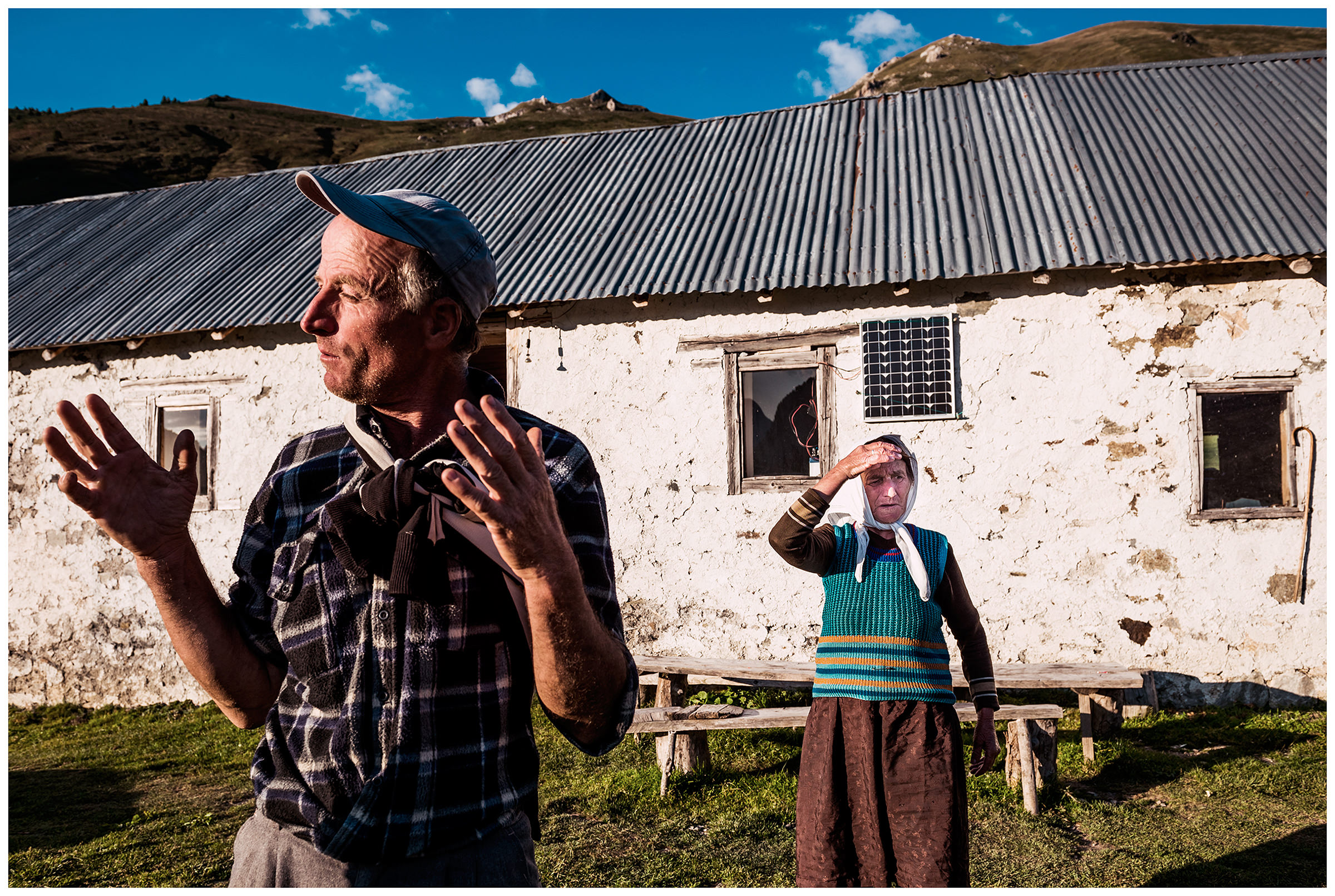 Doberdol, Albania. A villager and his mother are standing in front of their house in the mountains.