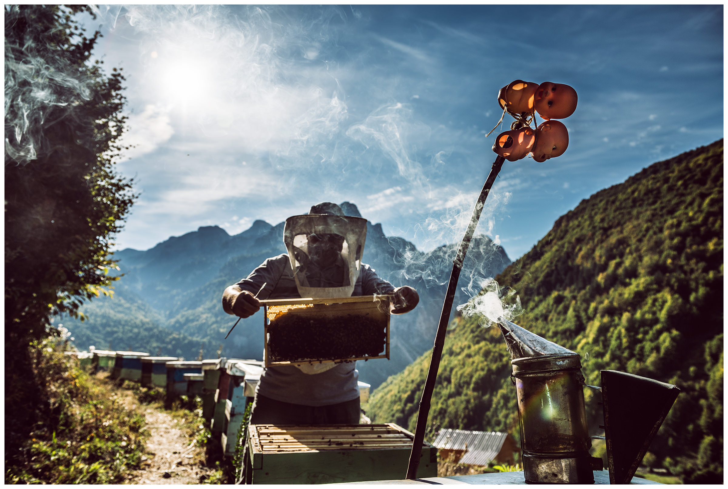 Cerem, Albania. A beekeeper takes care of his hives. The pupae on the hive serve as protection against evil eyes and evil spirits.