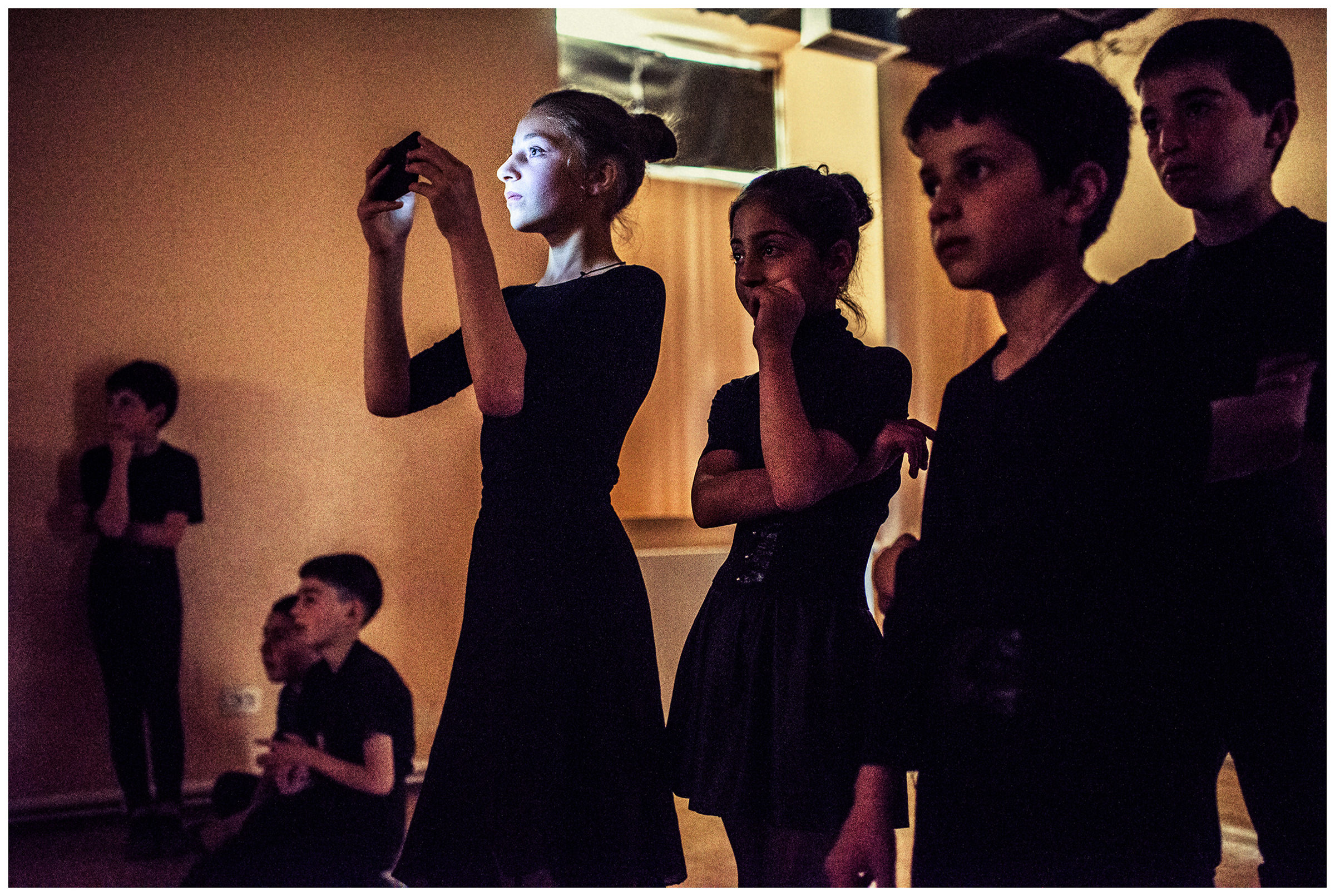Georgia, Nikosi village. The children from the church school watch the video recordings of their shadow theatres.