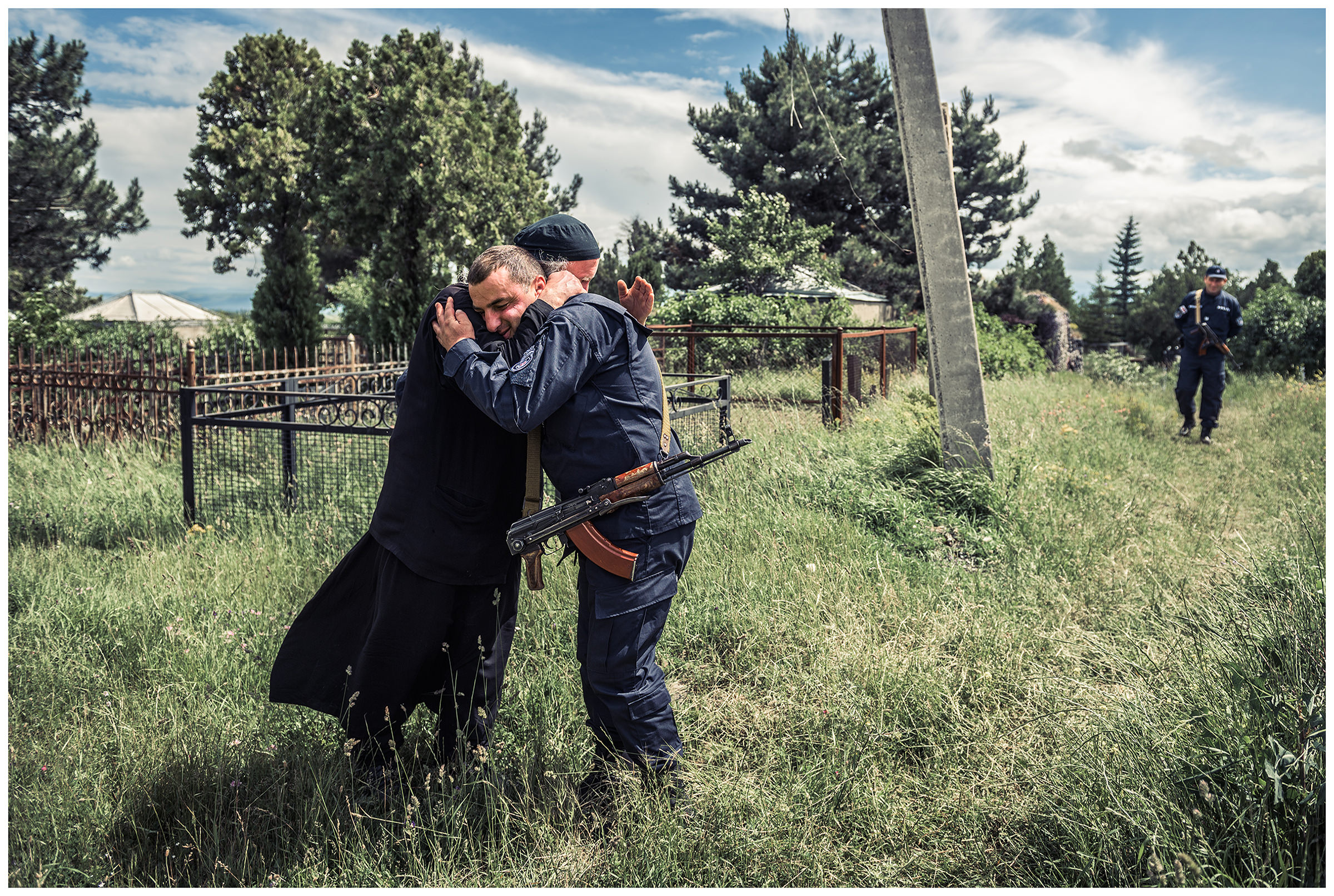 A Georgian priest greets a border policeman.