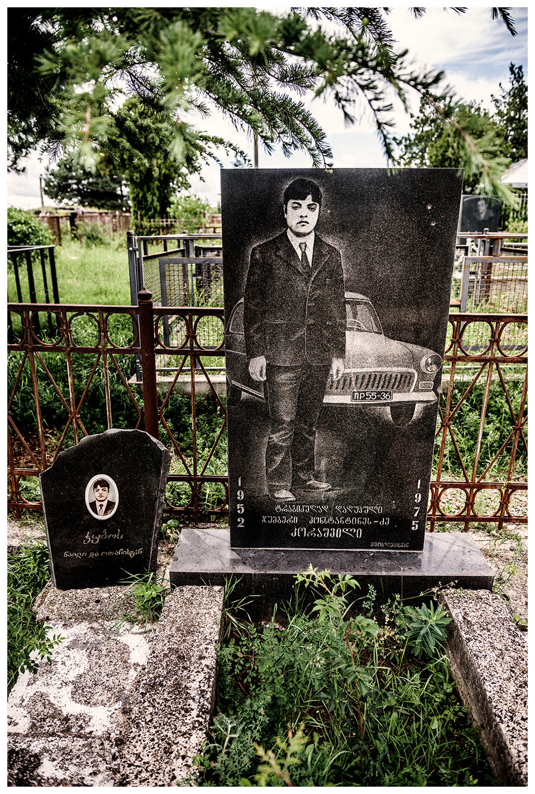 Georgia, Nikosi village. A gravestone with a man and his car on it stands in a cemetery at the Georgian-South Ossetian border.