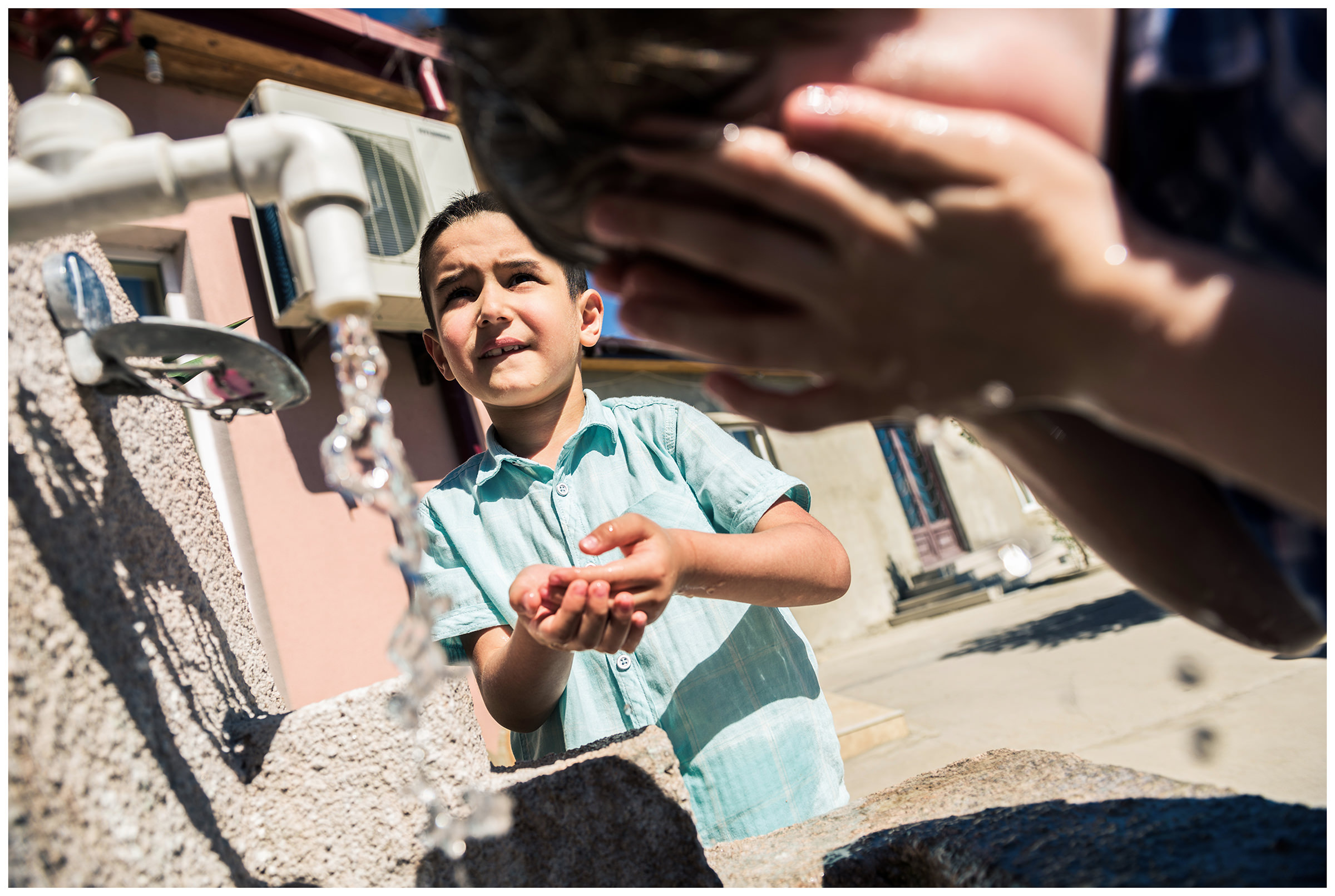 Georgia, Khashmi. Children of the guests wash themselves on the commemoration day in honour of the Georgian writer Giorgi Leonidze.