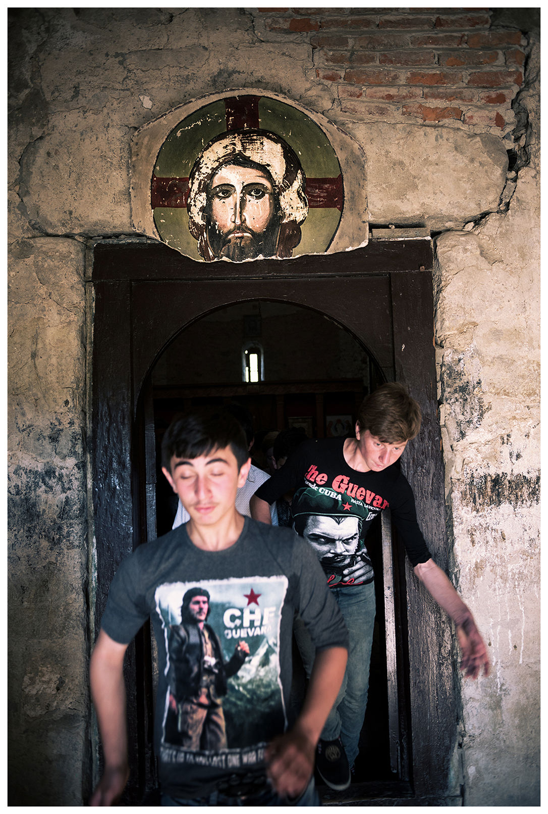 Georgia, Kakheti, near Telavi. Two boys in Che Guevara T-shirts leave the Iqalto monastery. The monastery was founded in the second half of the 6th century by Zenon Iqaltoeli, a Christian religious founder who belonged to the so-called 13 Syrian fathers.