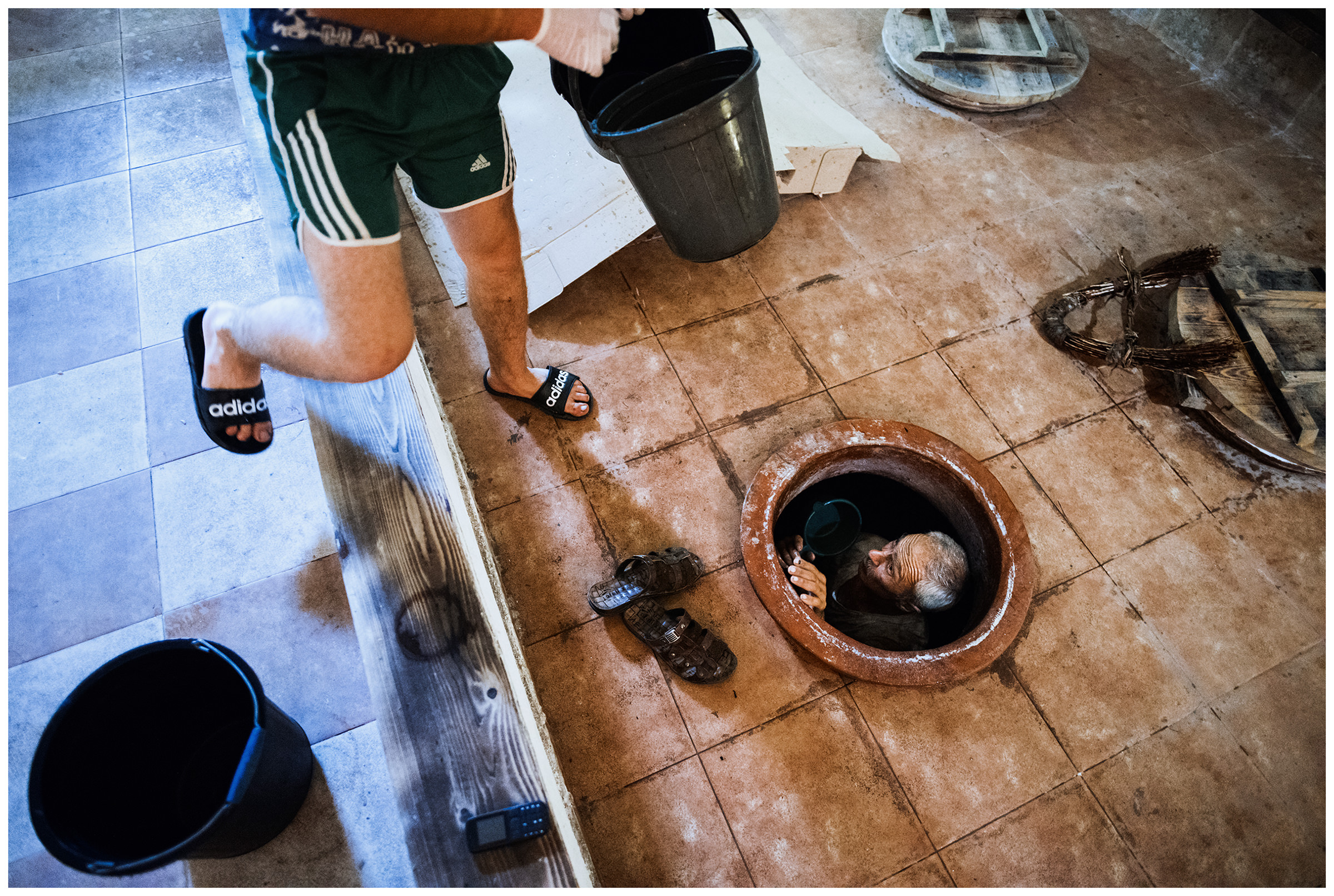 Akhasheni, Kakheti, Georgia. A man cleaning a clay amphora, the Qvevri, in the Papari Valley winery.