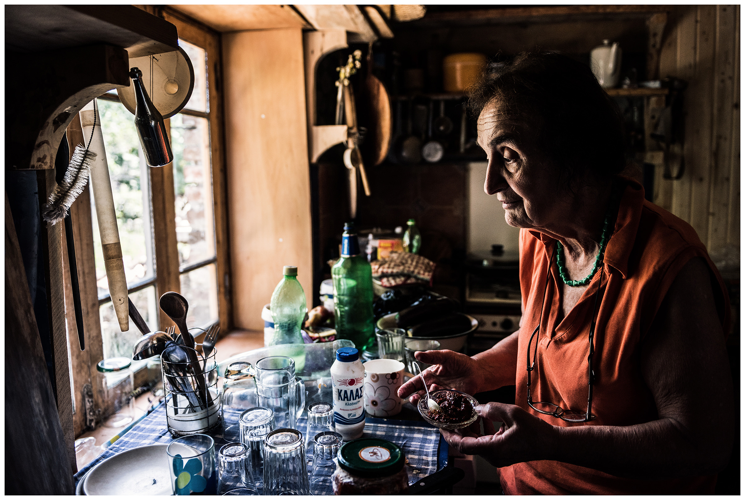 Kardenakhi, Gurjaani parish, Kakheti, Georgia. A winemaker gets a spicy side dish from the kitchen for a wine tasting.