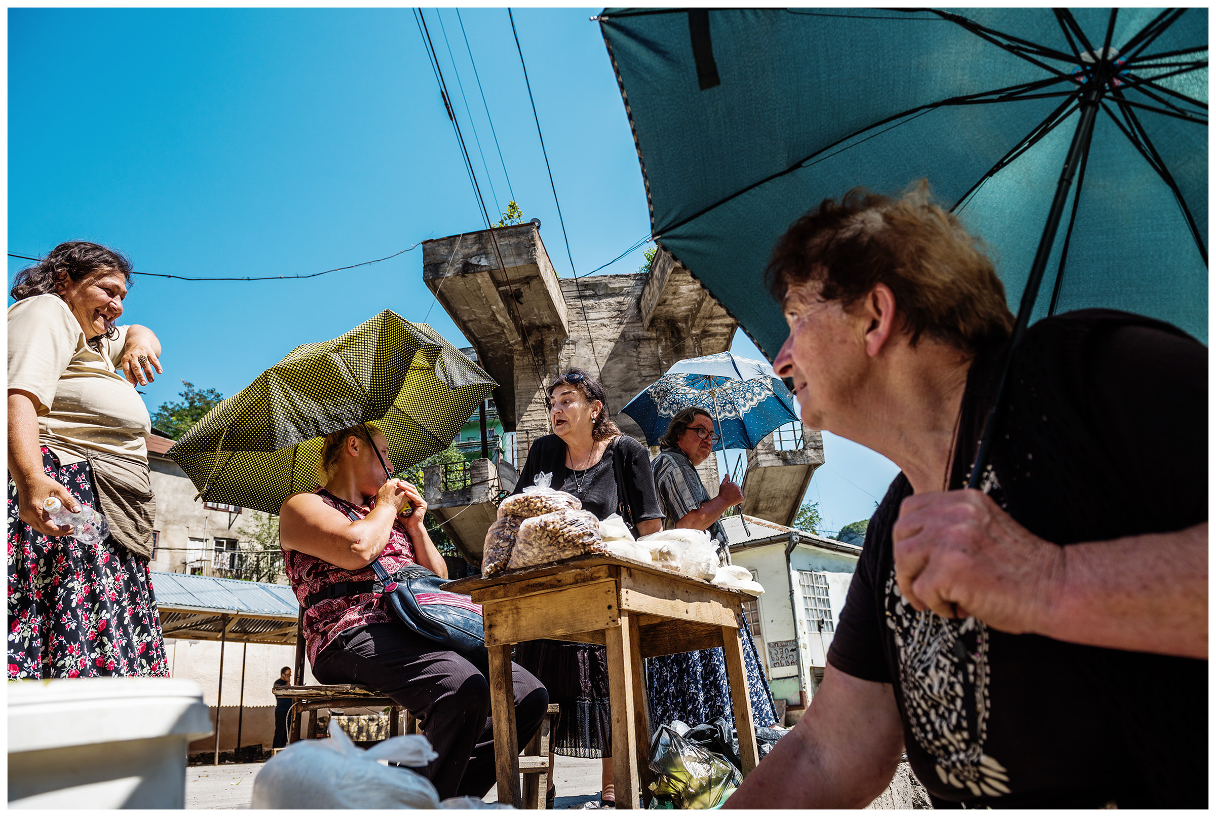 Chiatura, Imeretia, Georgia. Vegetable sellers are sitting at a small street market in Chiatura.