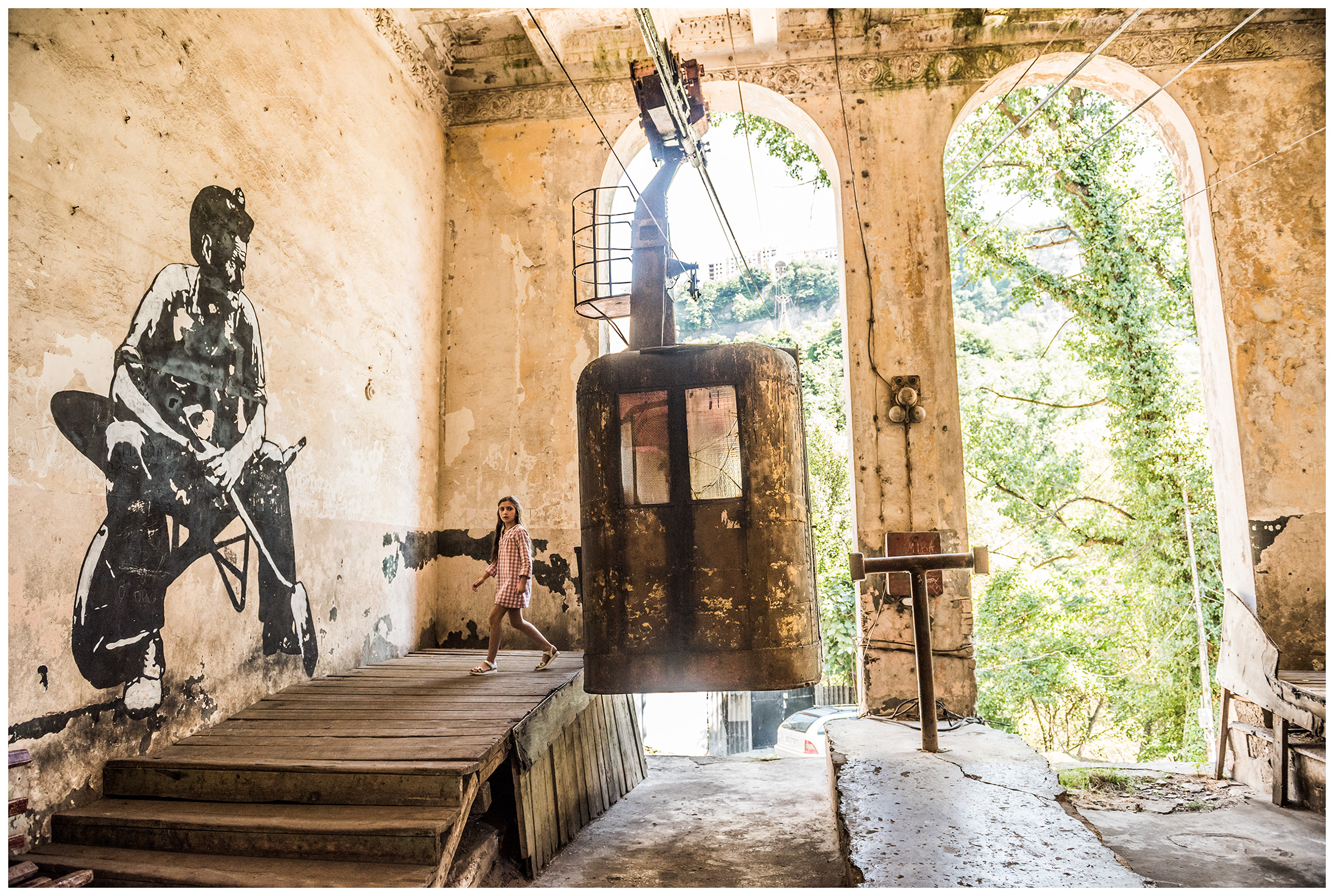 Chiatura, Imeretia, Georgia. A girl comes out of a cable car.