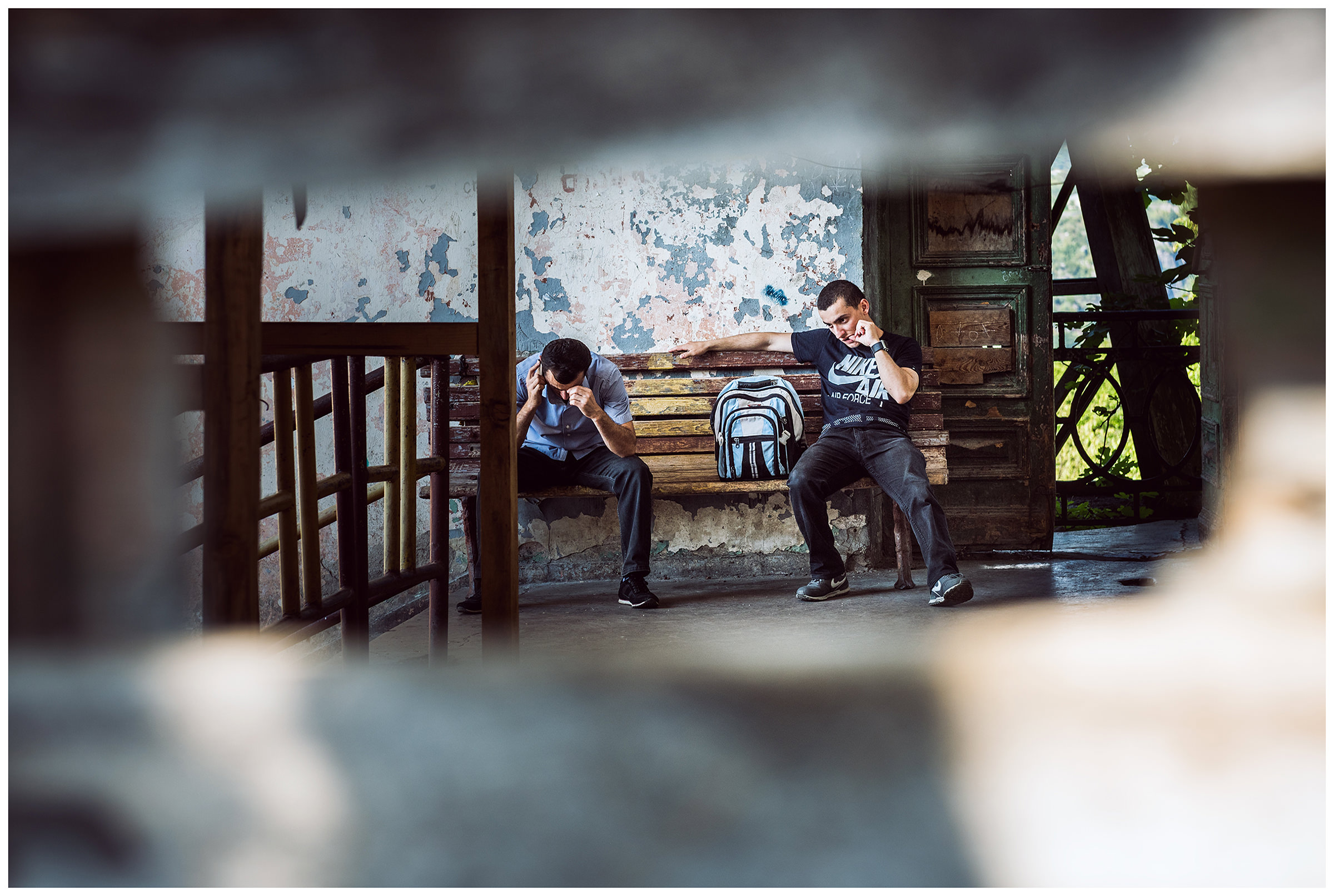 Chiatura, Imeretia, Georgia. Two young men waiting for the departure of a cable car gondola. The gondola of the cable car in Tschiatura is often referred to as the "iron coffin".