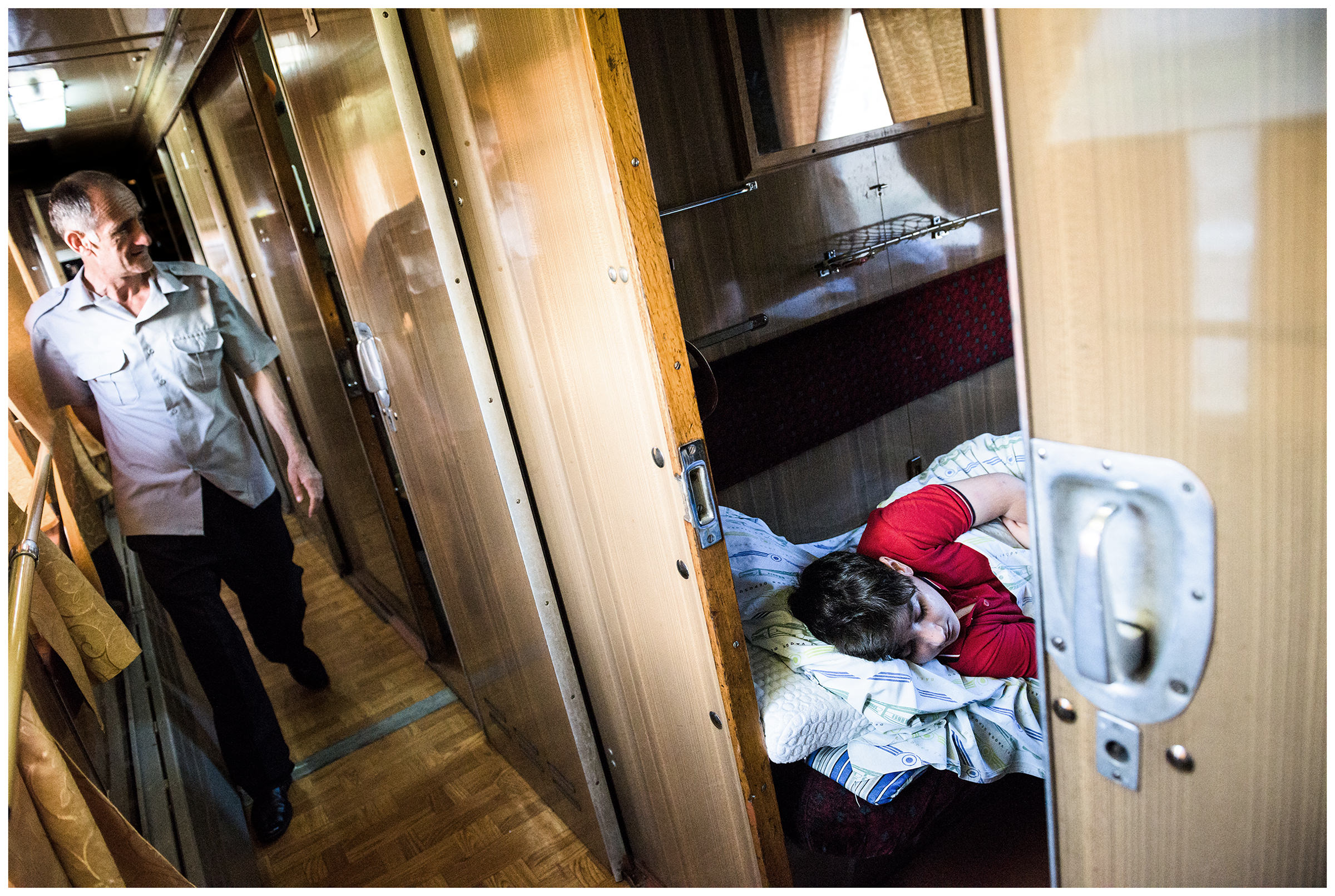 A boy sleeps in a compartment in an old Soviet train that goes from Ganja to Baku.