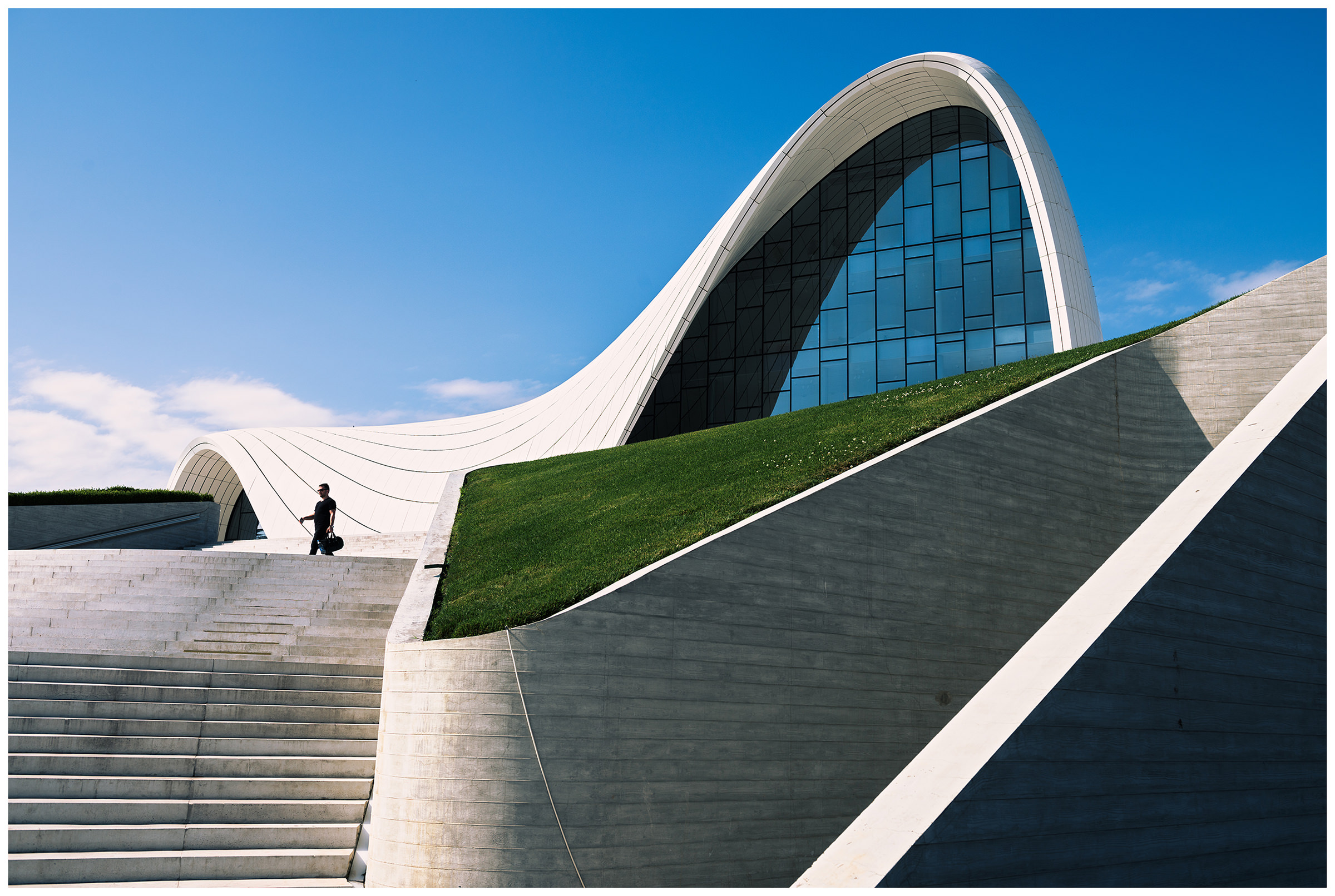 Azerbaijan, Baku. A man walks down a staircase in front of the Aliyev Museum.