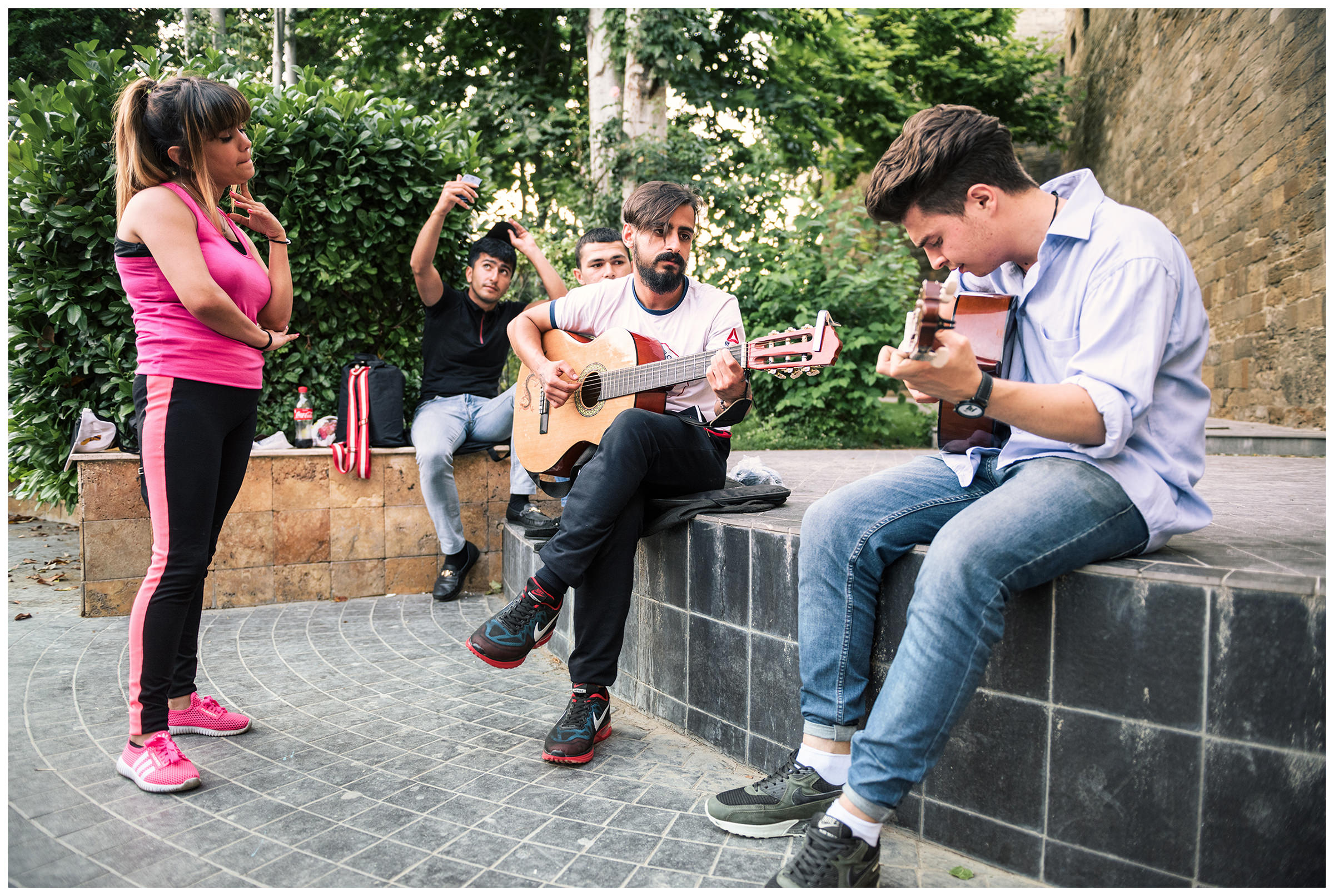 Azerbaijan, Baku. Youth play guitar in the old town of Baku.