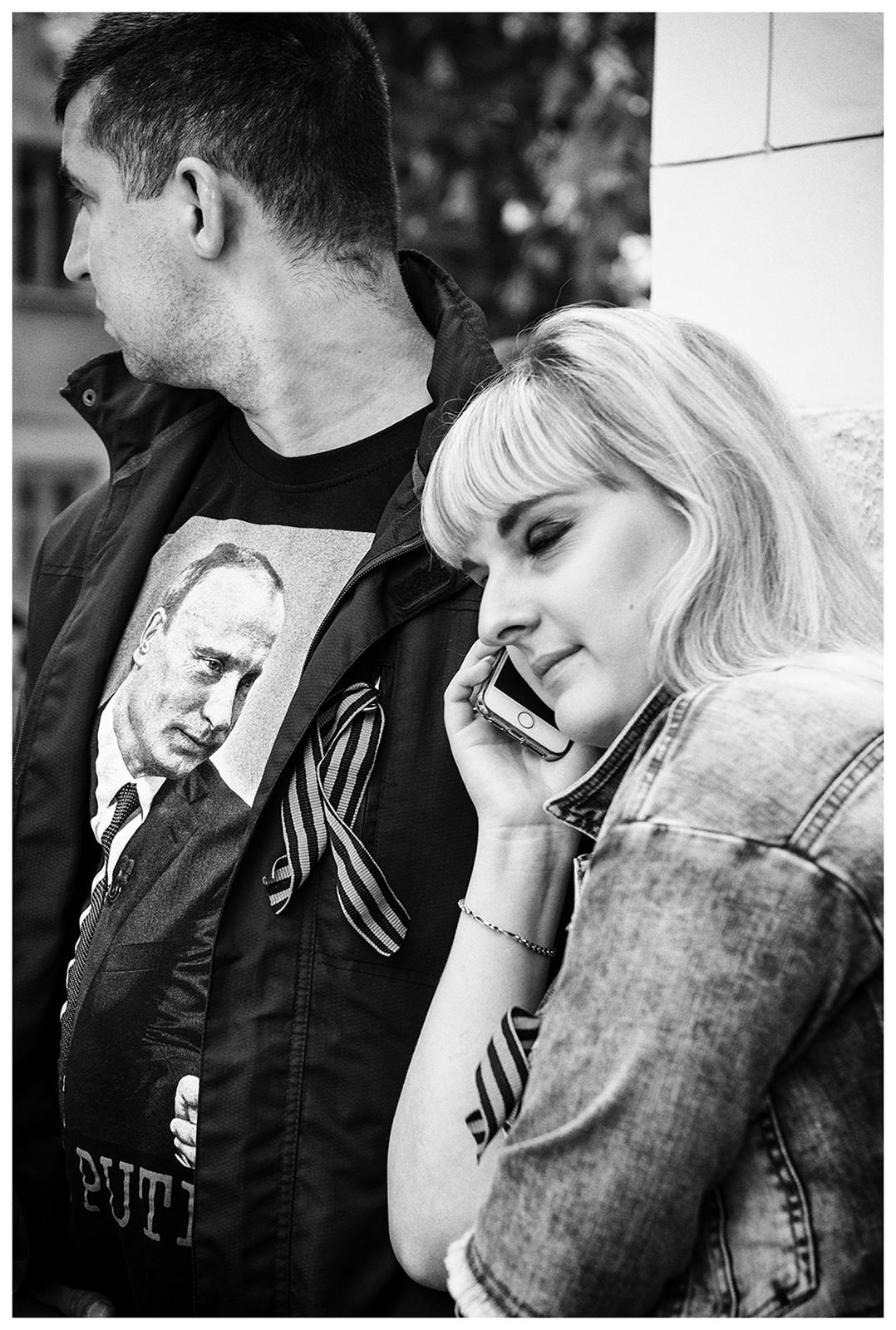 Sevastopol, the Crimea. A participant of the military parade in a Putin T-shirt is making a phone call at the roadside. The military parade takes place on the occasion of the victory over Nazi Germany on May 9.