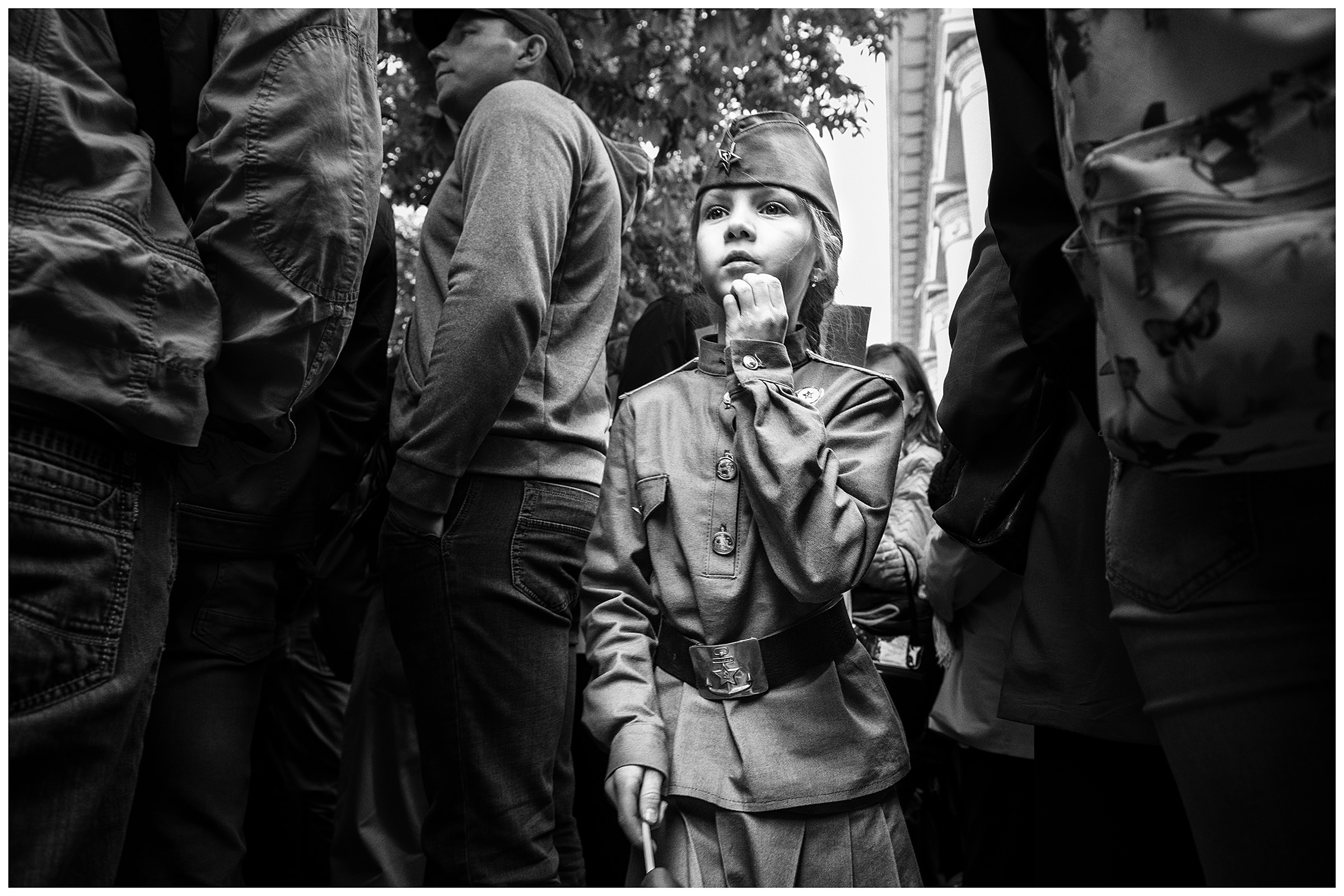 Sevastopol, the Crimea. A uniformed girl pushes her way through the crowd during the military parade. The military parade takes place on the occasion of the victory over Nazi Germany on May 9.